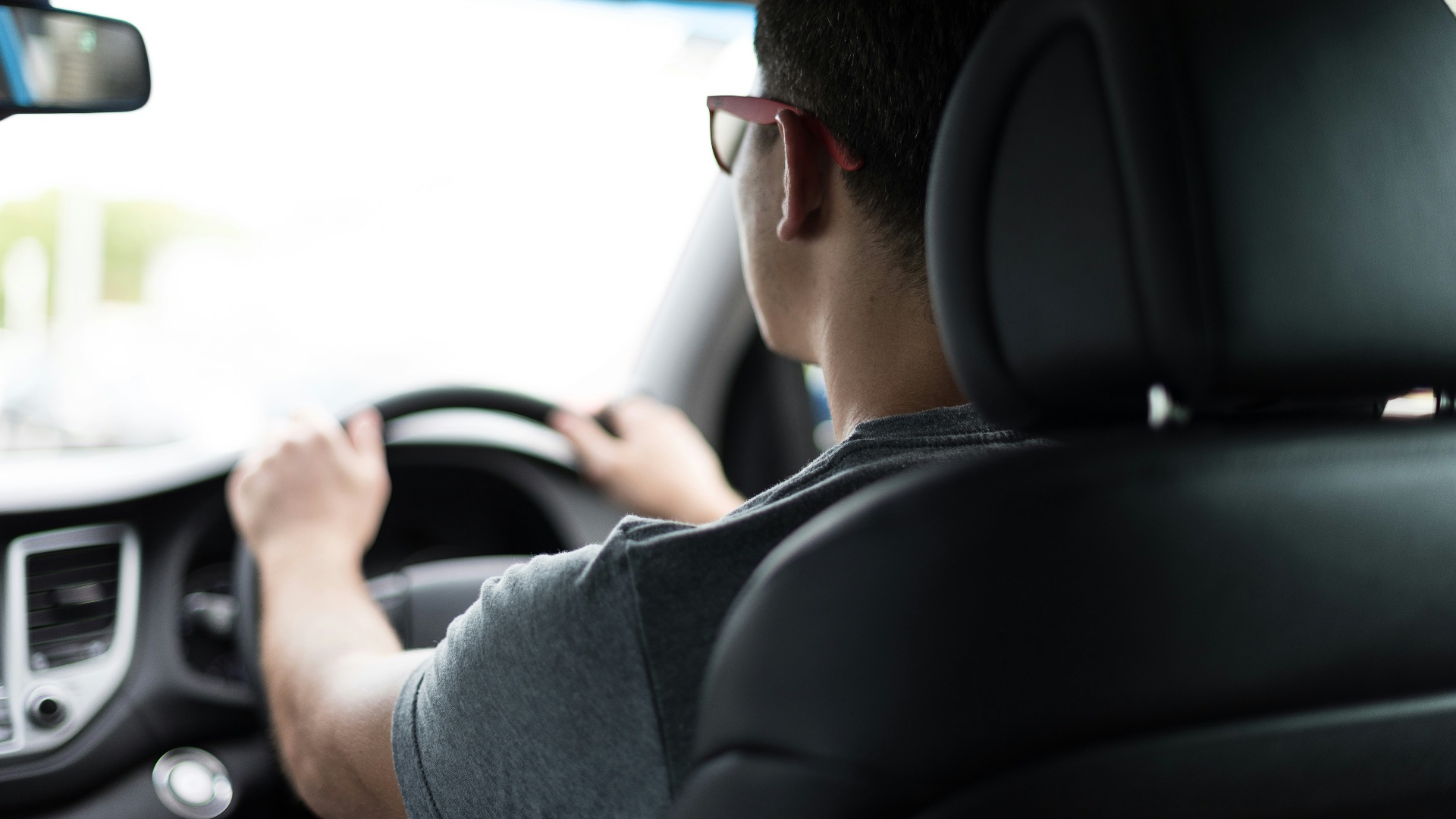 man driving car during daytime