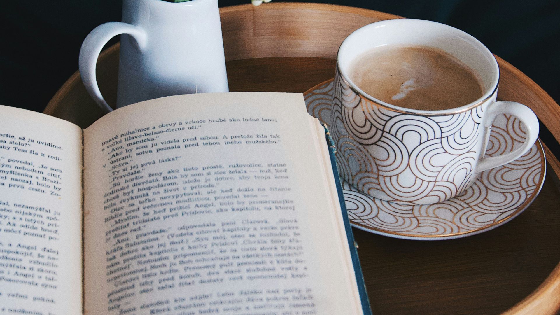 white and blue ceramic mug on brown wooden table