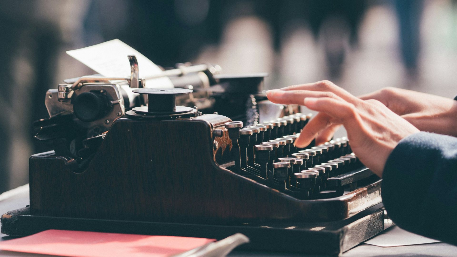 person using black typewriter