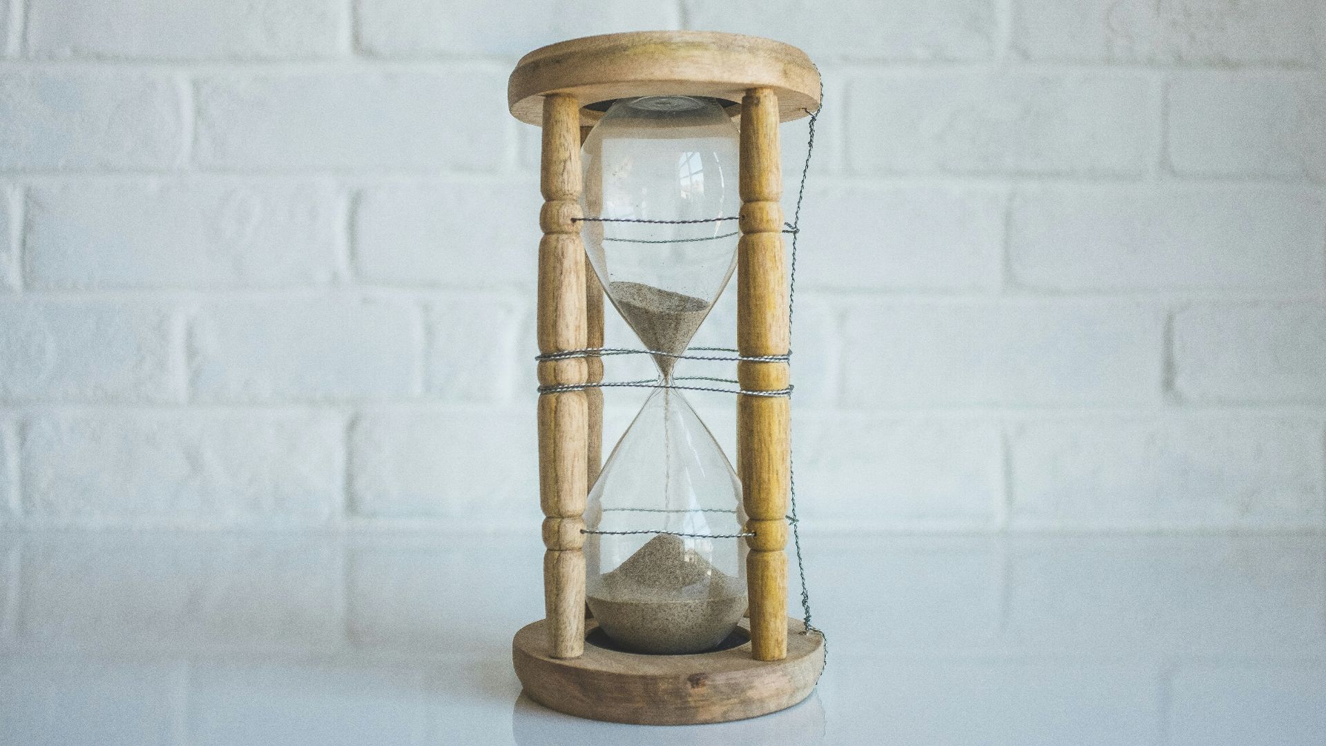 clear hour glass with brown frame