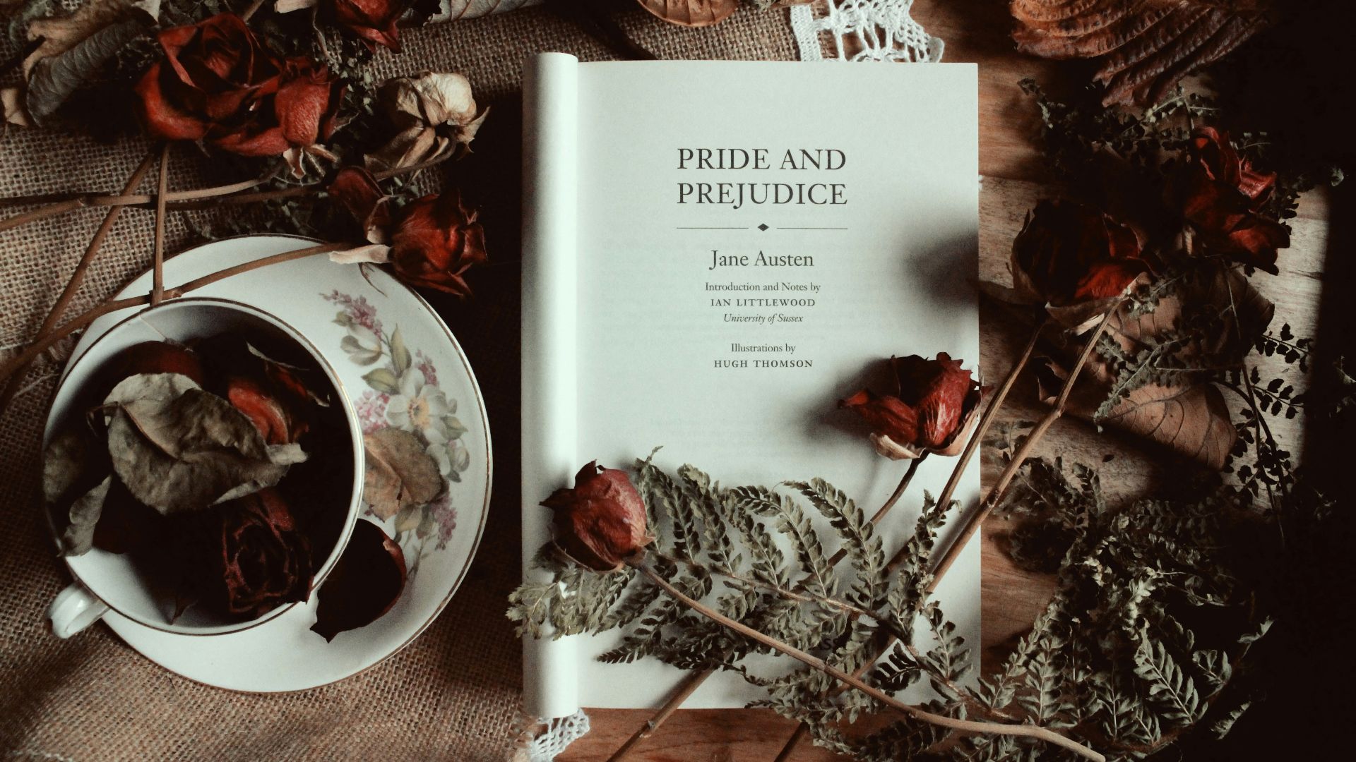 a book sitting on top of a table next to a cup of tea