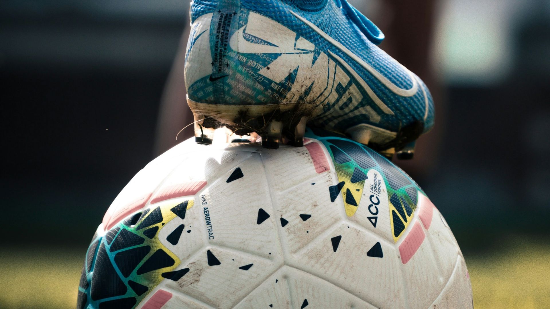 white and blue soccer ball on green grass field