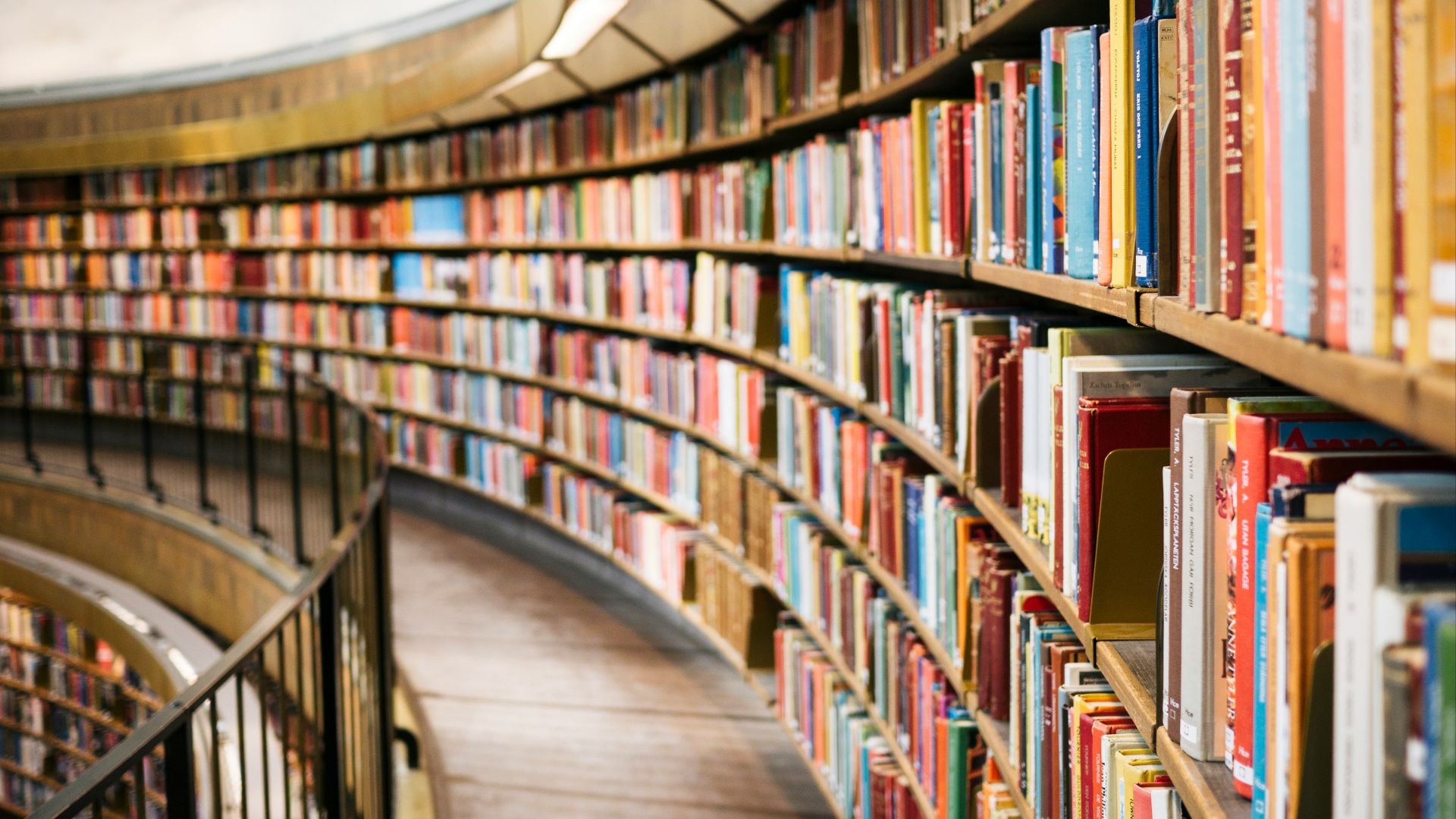 books on brown wooden shelf
