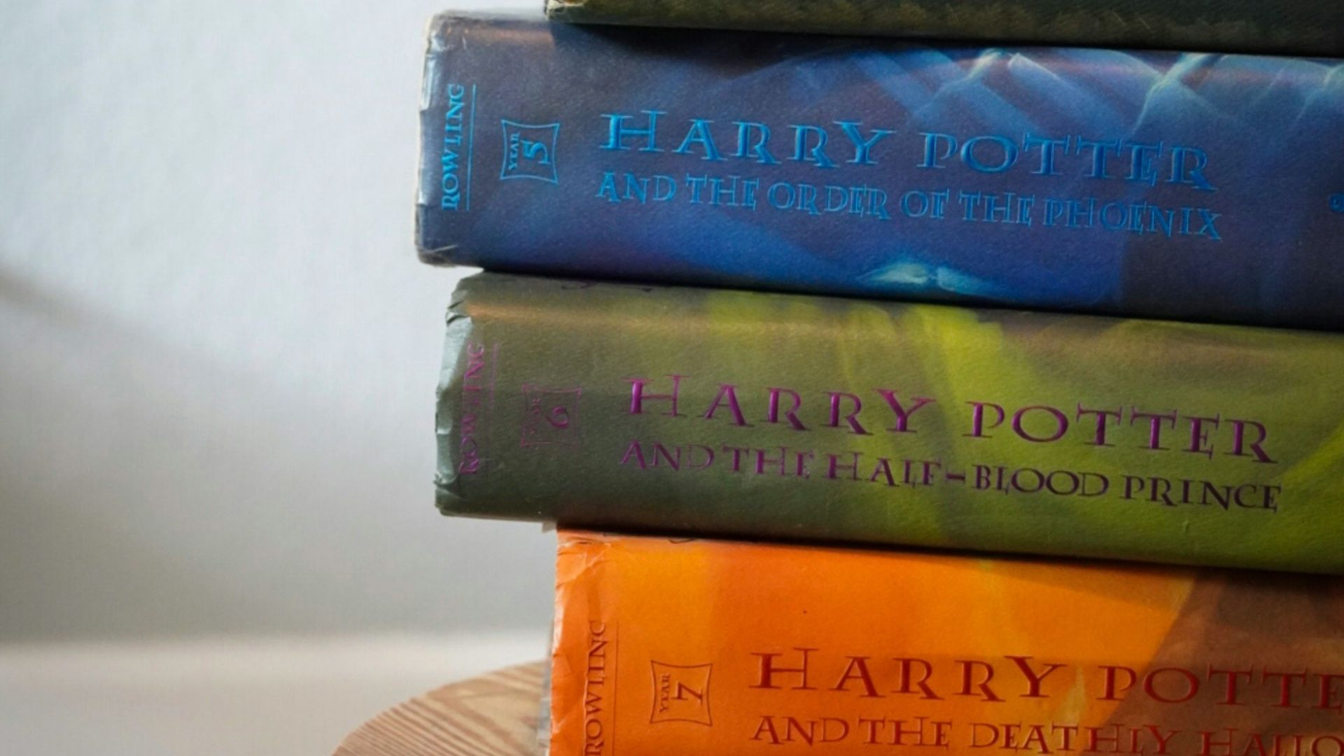 a stack of books sitting on top of a wooden table