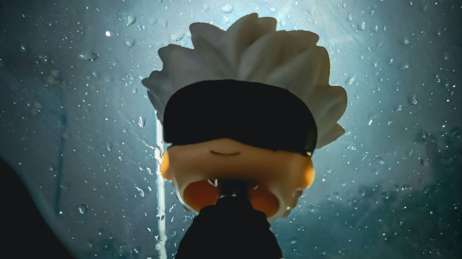 A person with a blindfolded head standing in front of a window