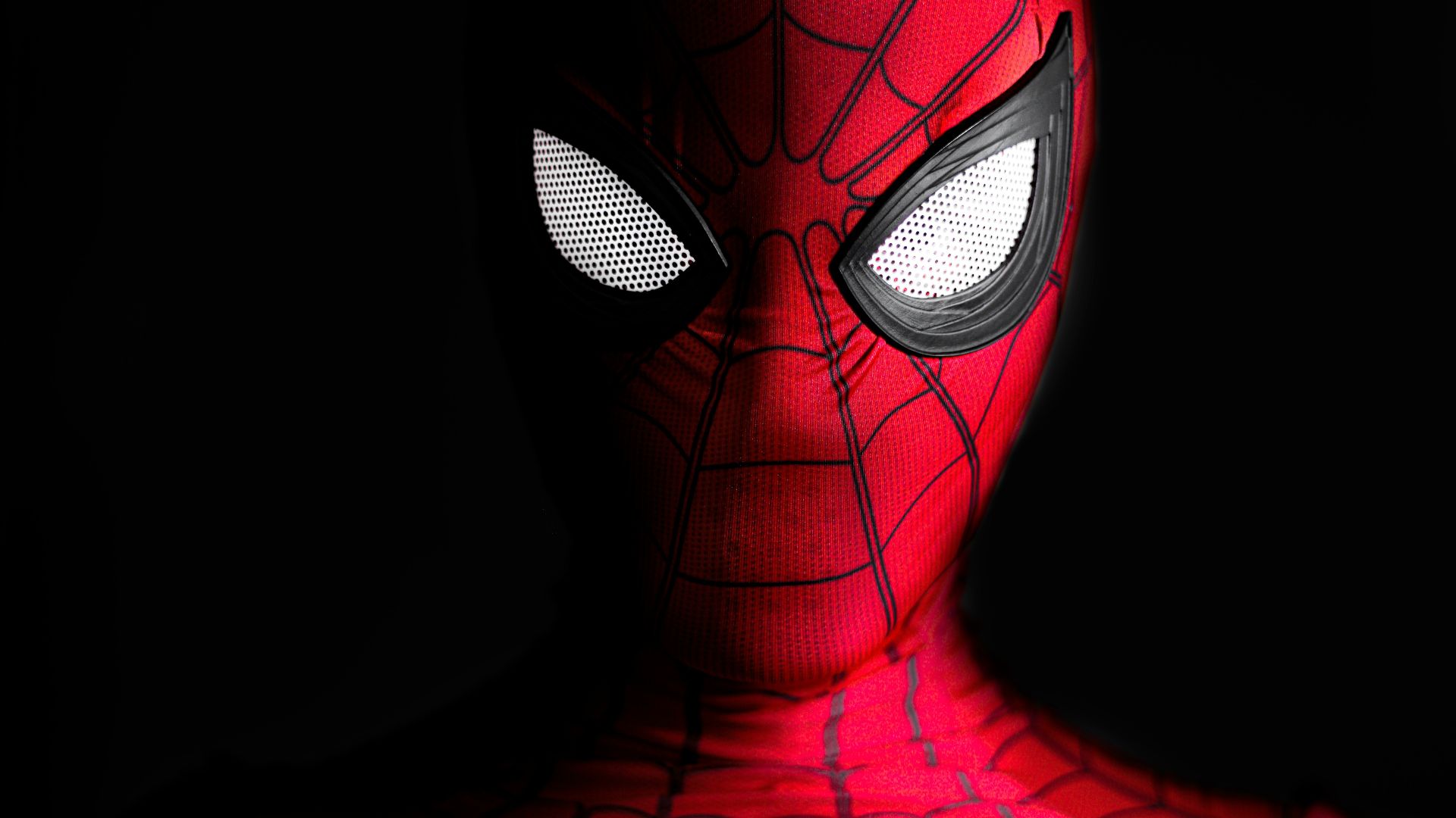 a close up of a spider man with glowing eyes