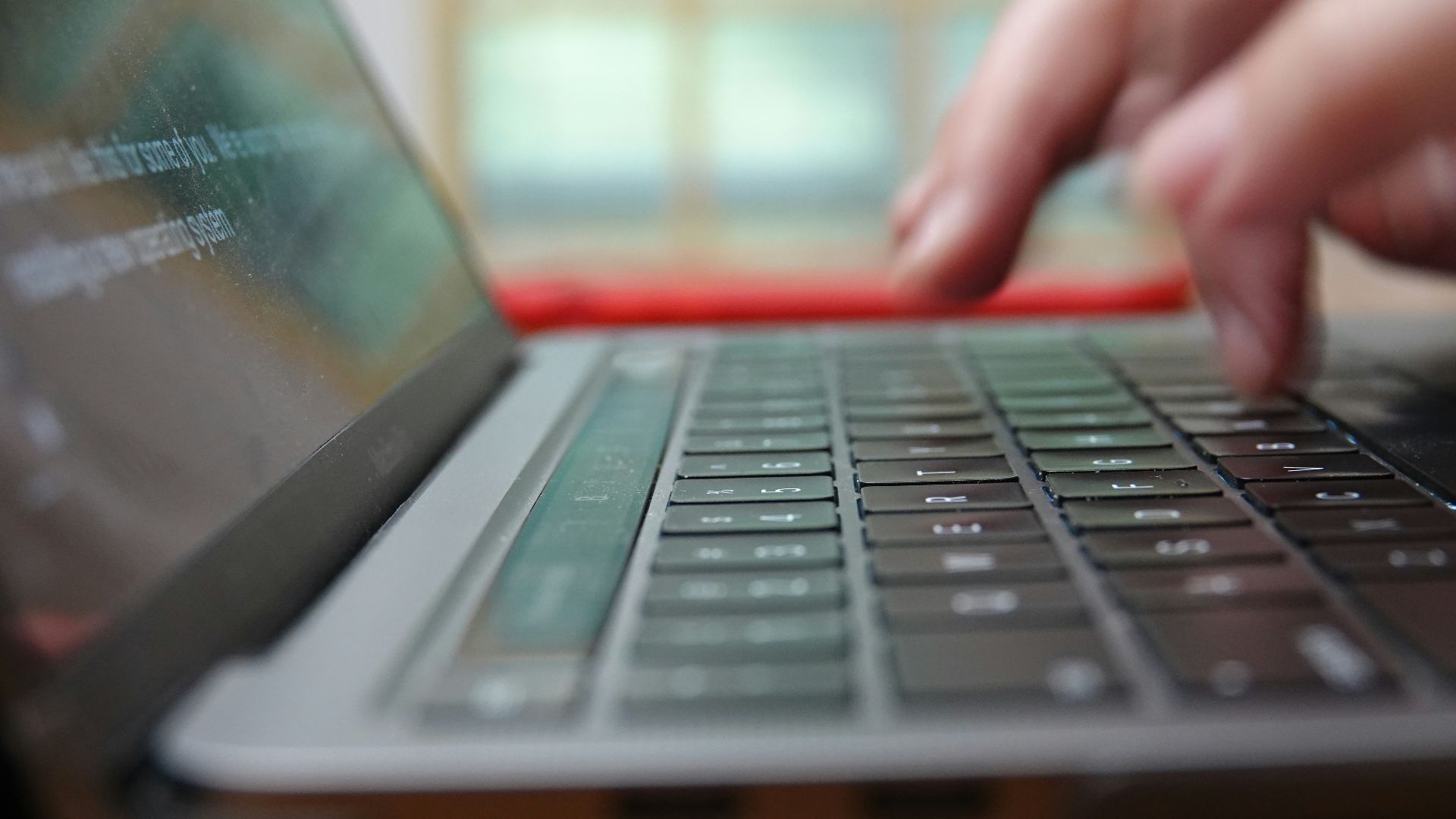 a close up of a person typing on a laptop