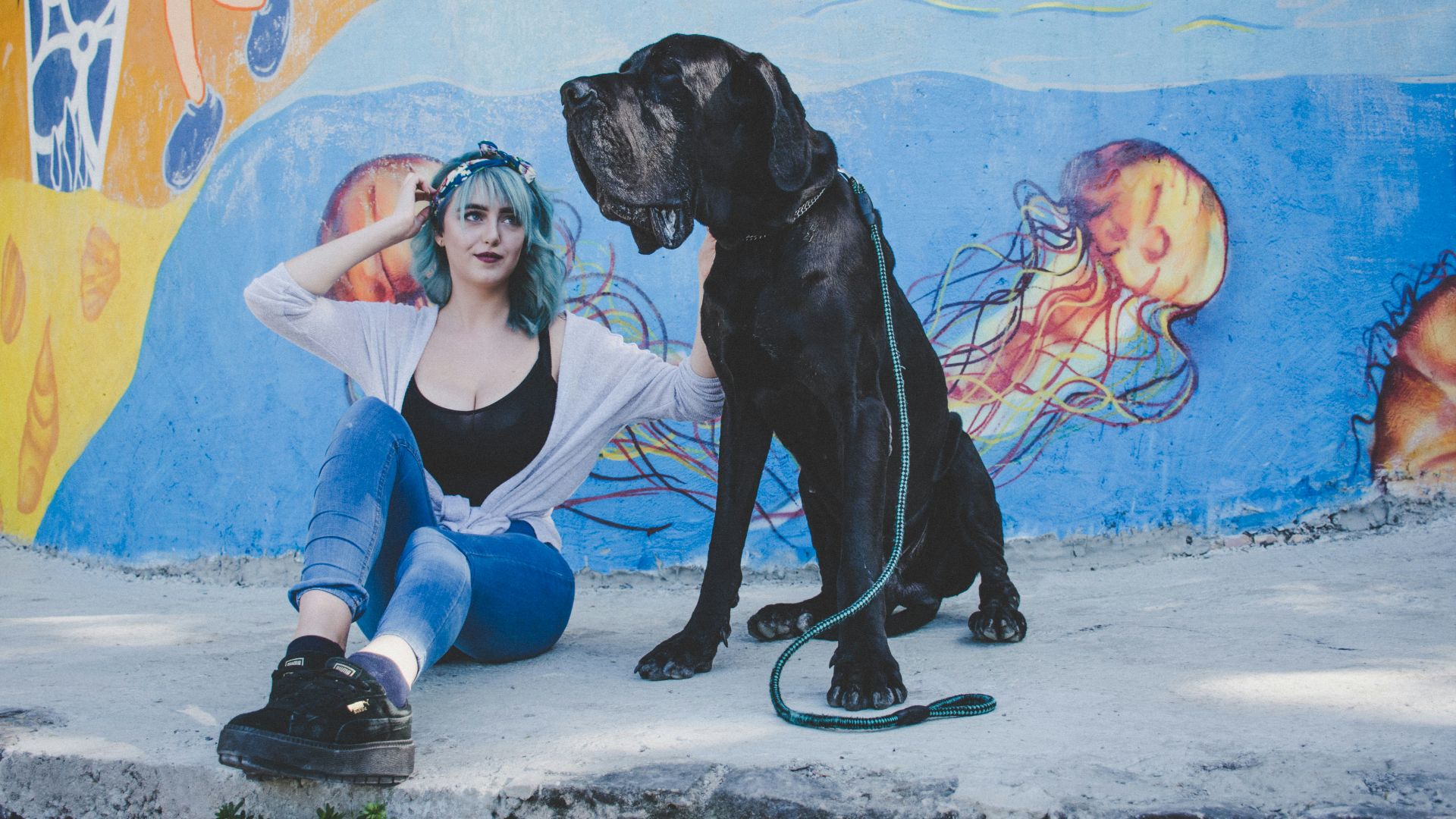 woman sitting on street with her dog