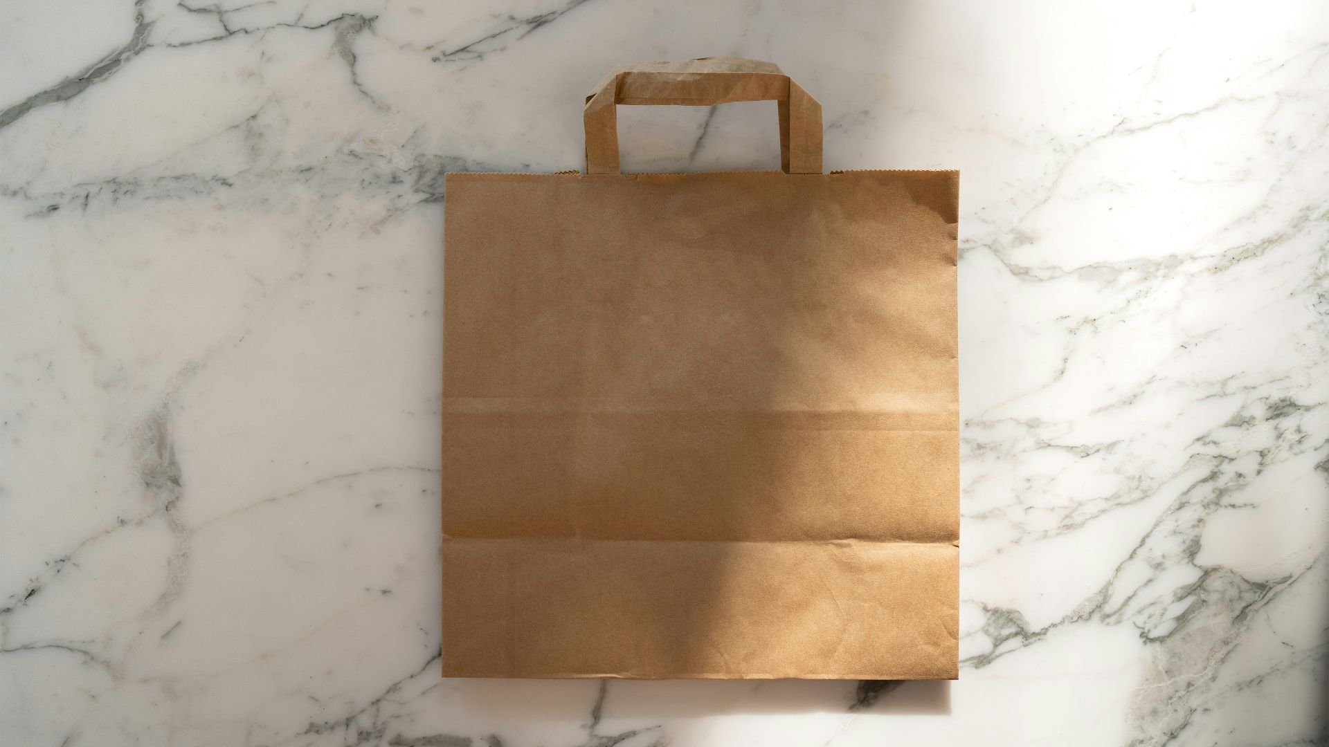 a brown paper bag sitting on top of a marble counter