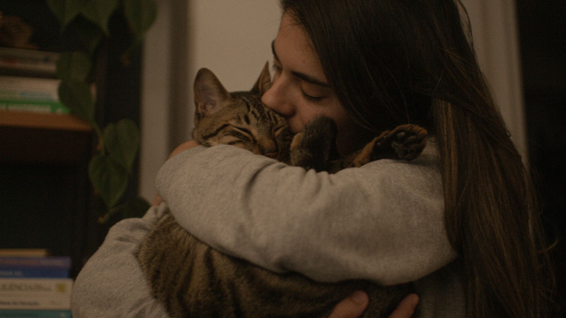 a woman holding a cat in her arms