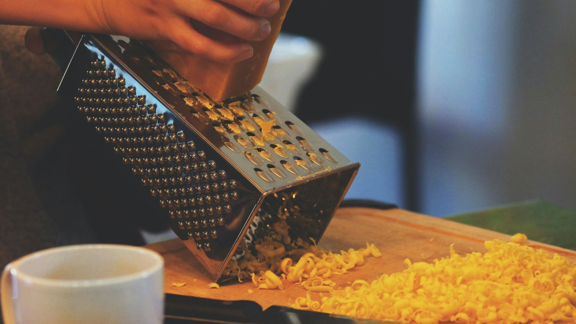 person grating cheese