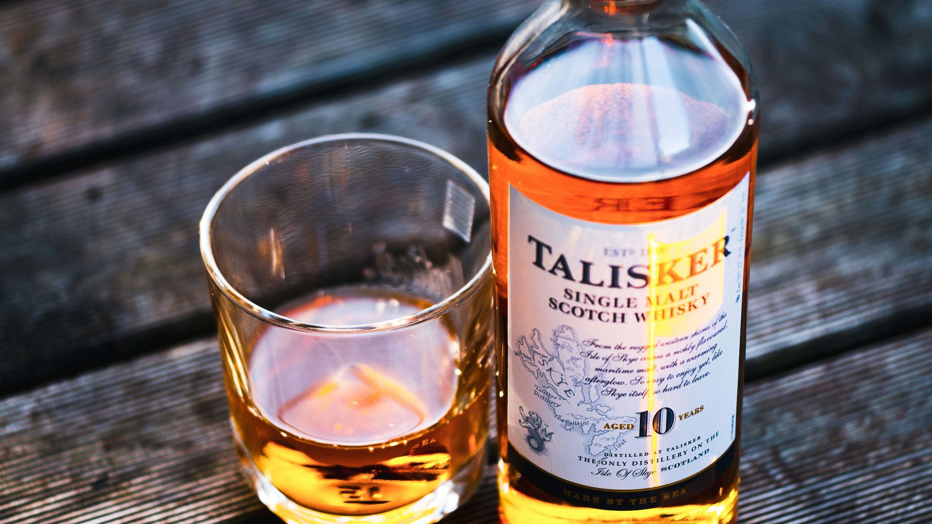 Talisker bottle beside drinking glass