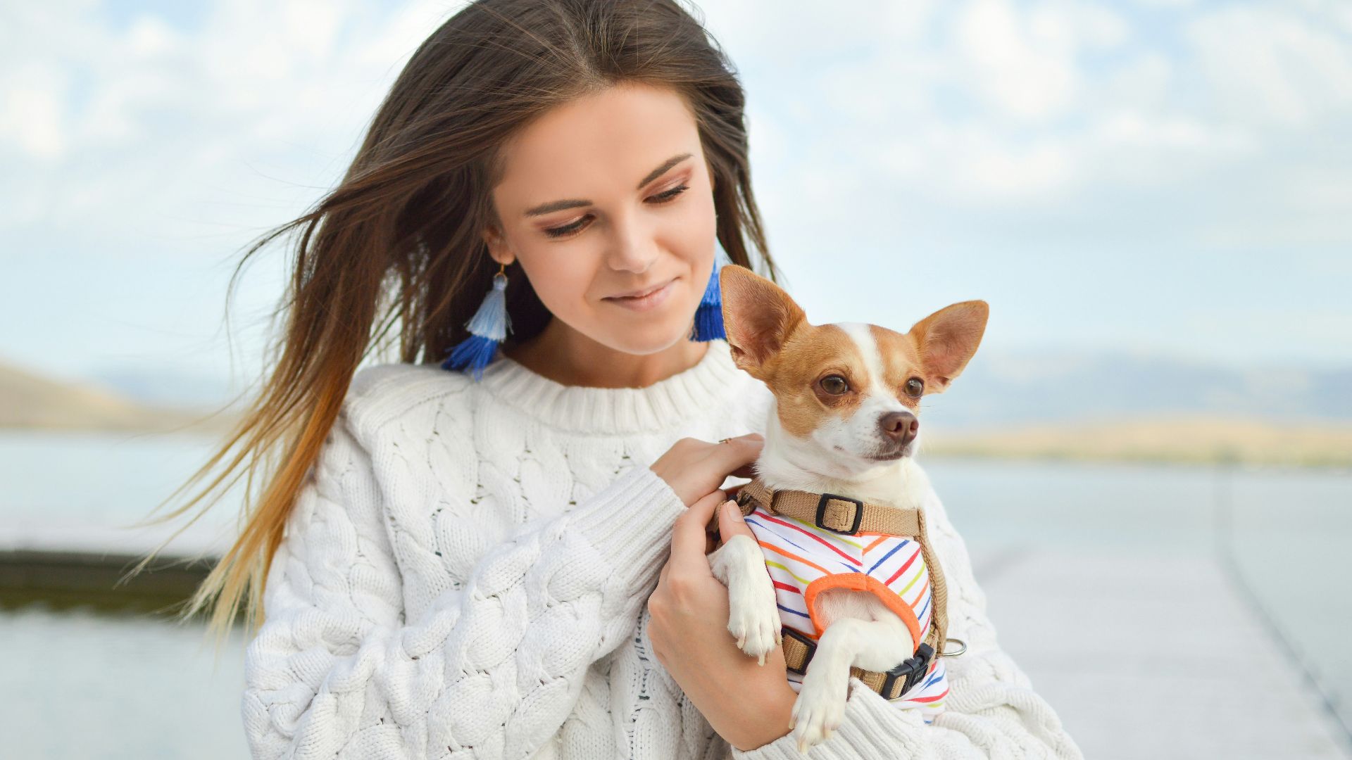 woman carrying dog close up photography