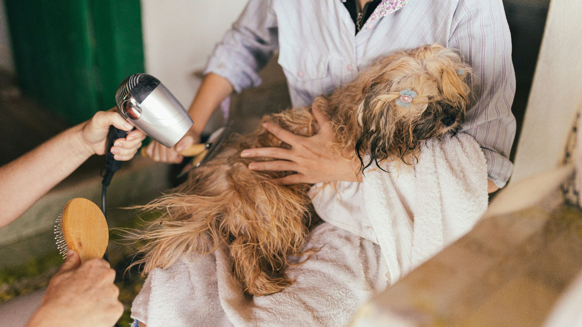woman in white robe holding hair blower