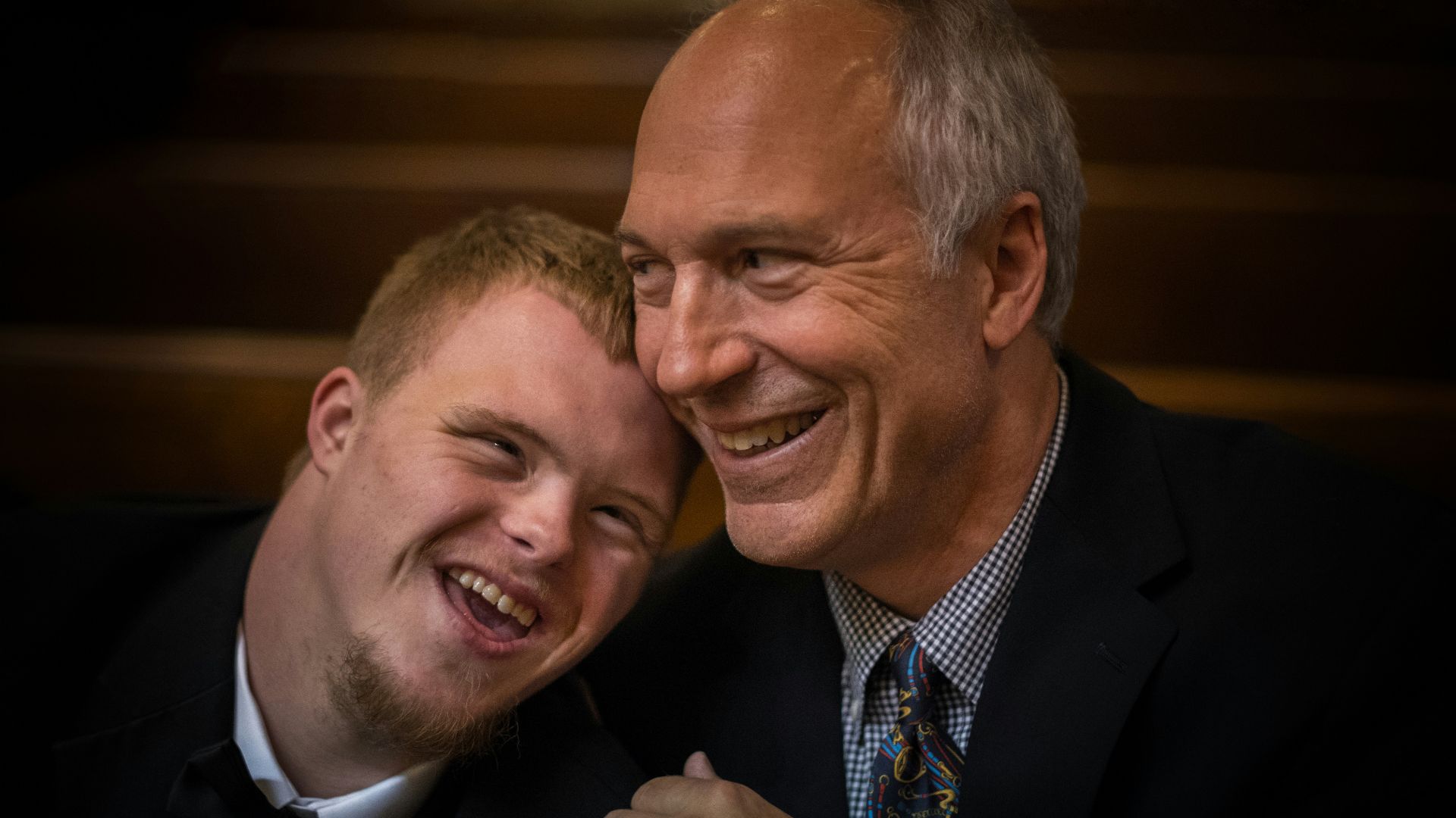 two man smiling on focus photography