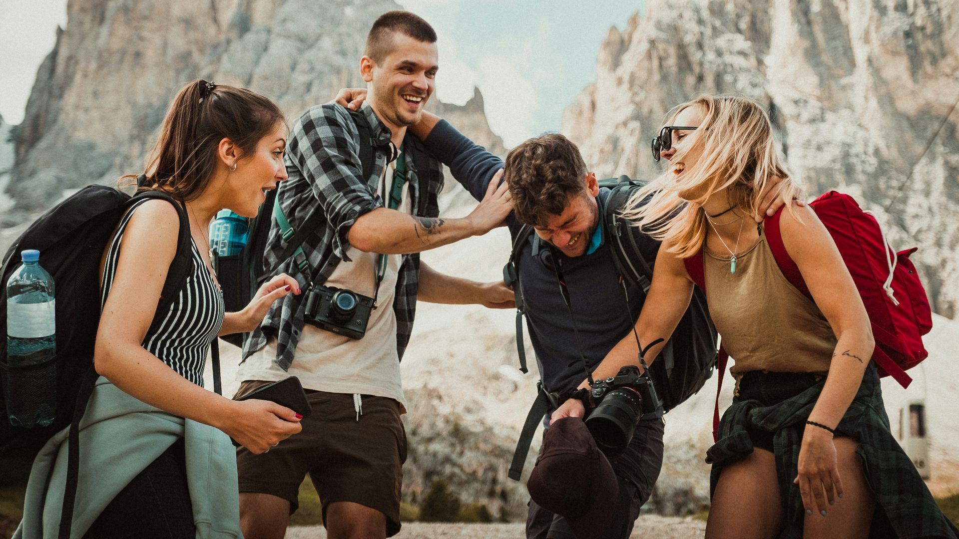 low-angle photography of two men playing beside two women