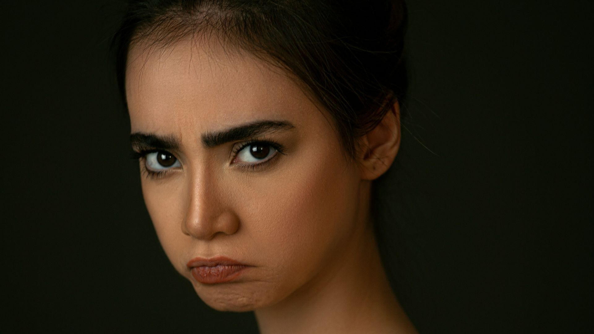 woman with brown hair and black eyes