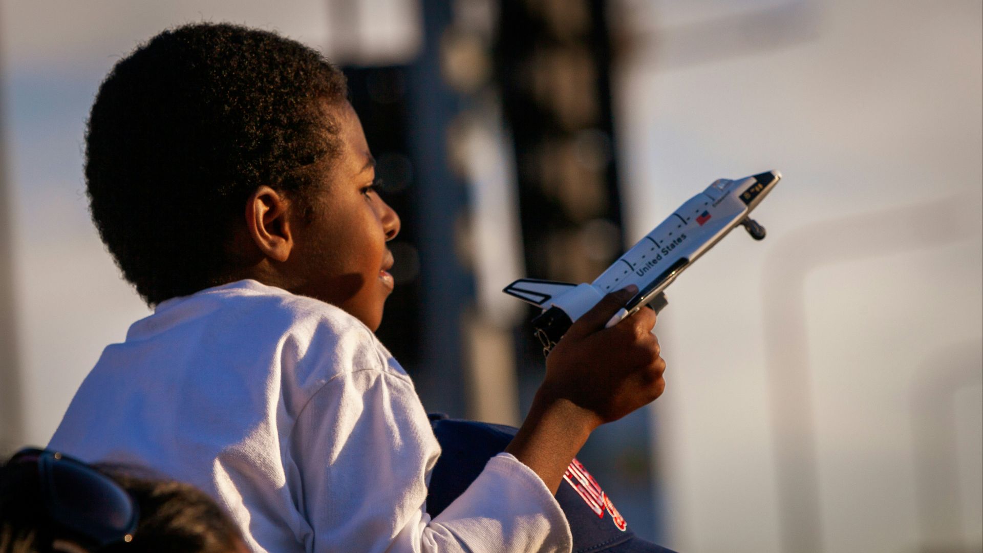 boy holding space shuttle