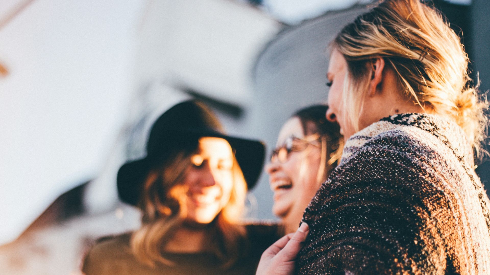 people laughing and talking outside during daytime