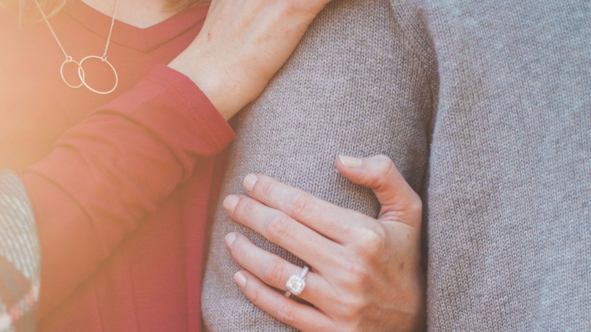 woman holding the shoulder of man