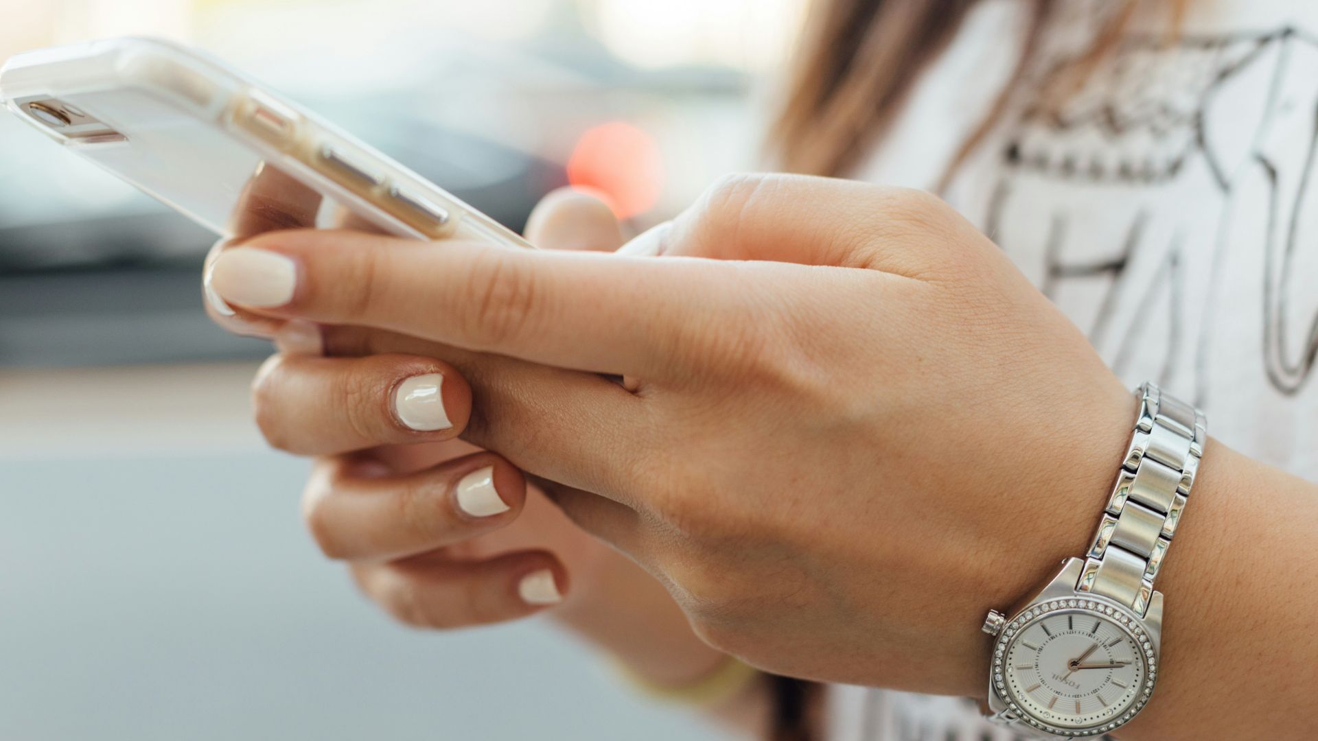 woman holding iPhone during daytime