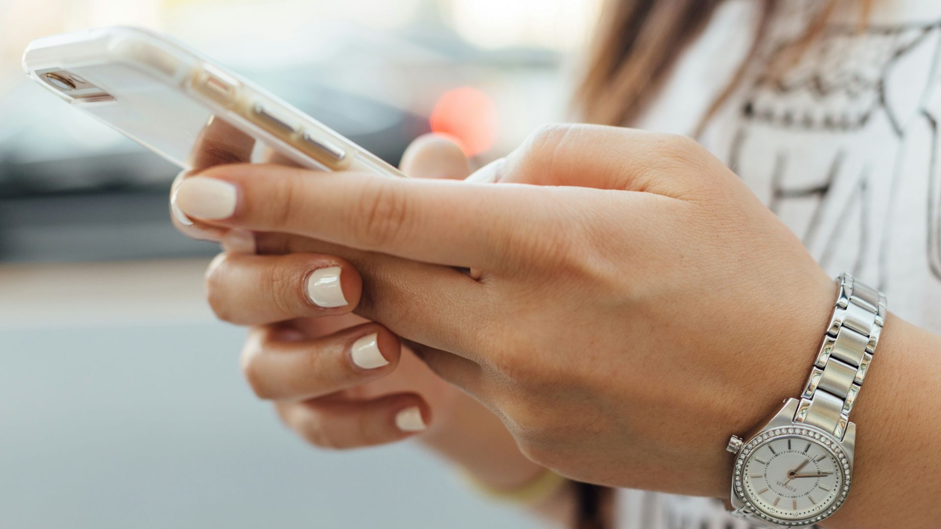 woman holding iPhone during daytime