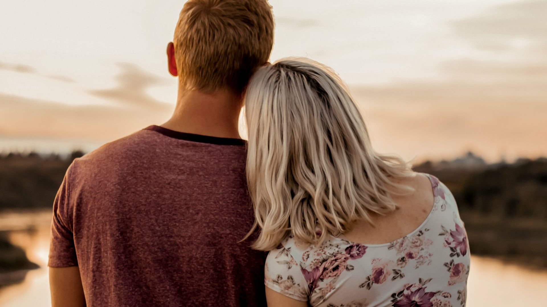 man and woman standing on brown field during daytime