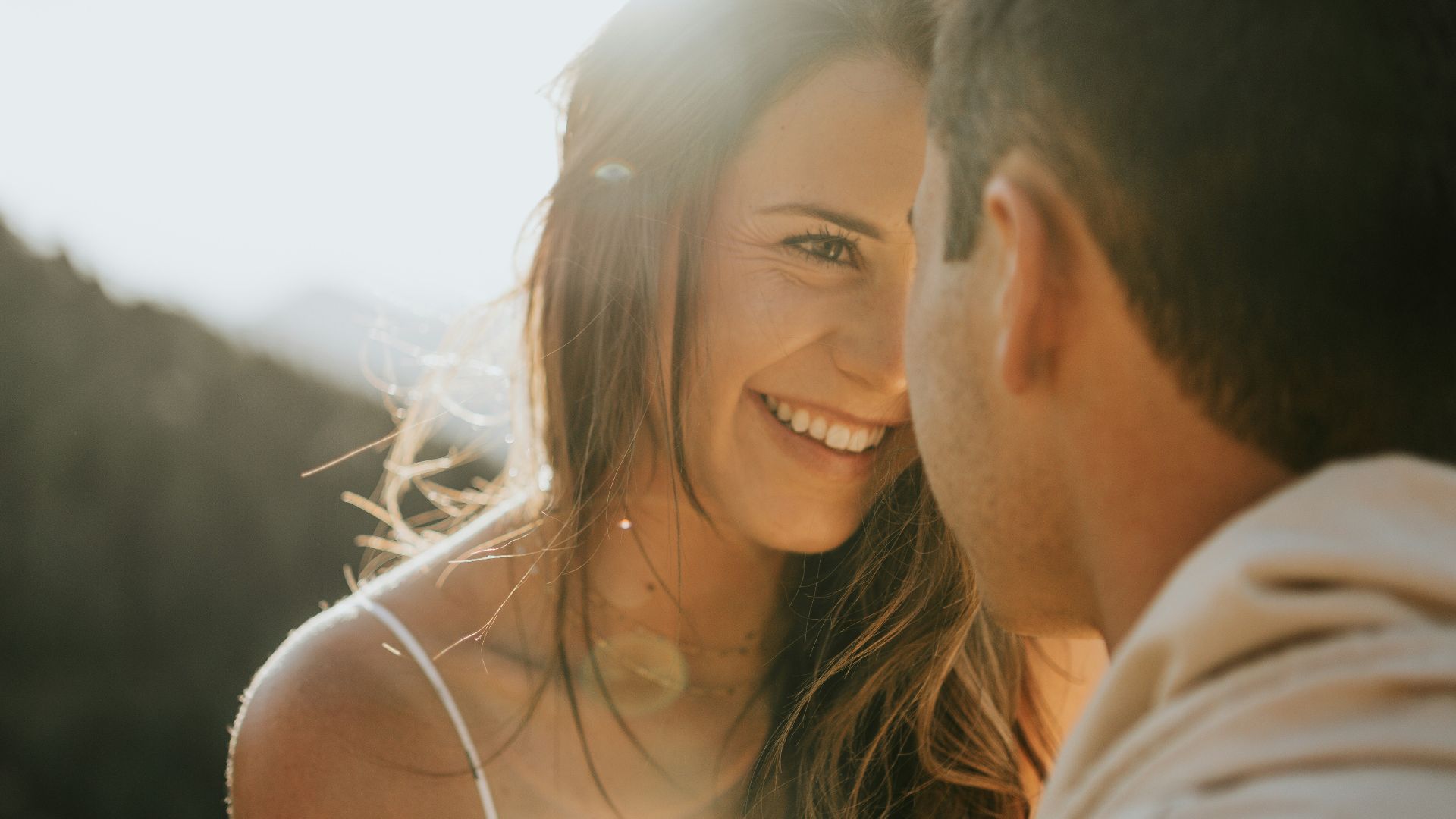man and woman kissing during daytime