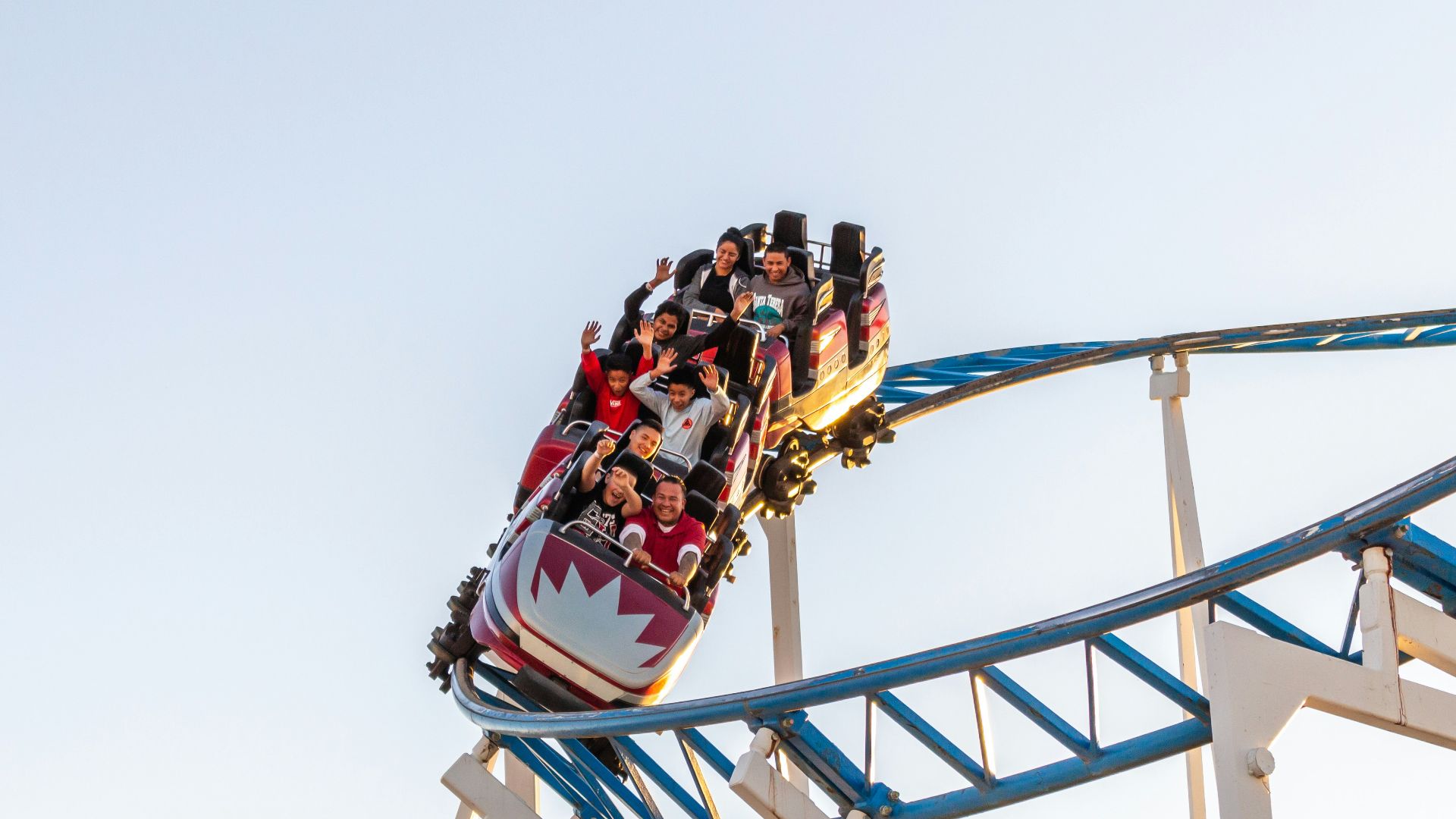 people riding roller coaster during daytime
