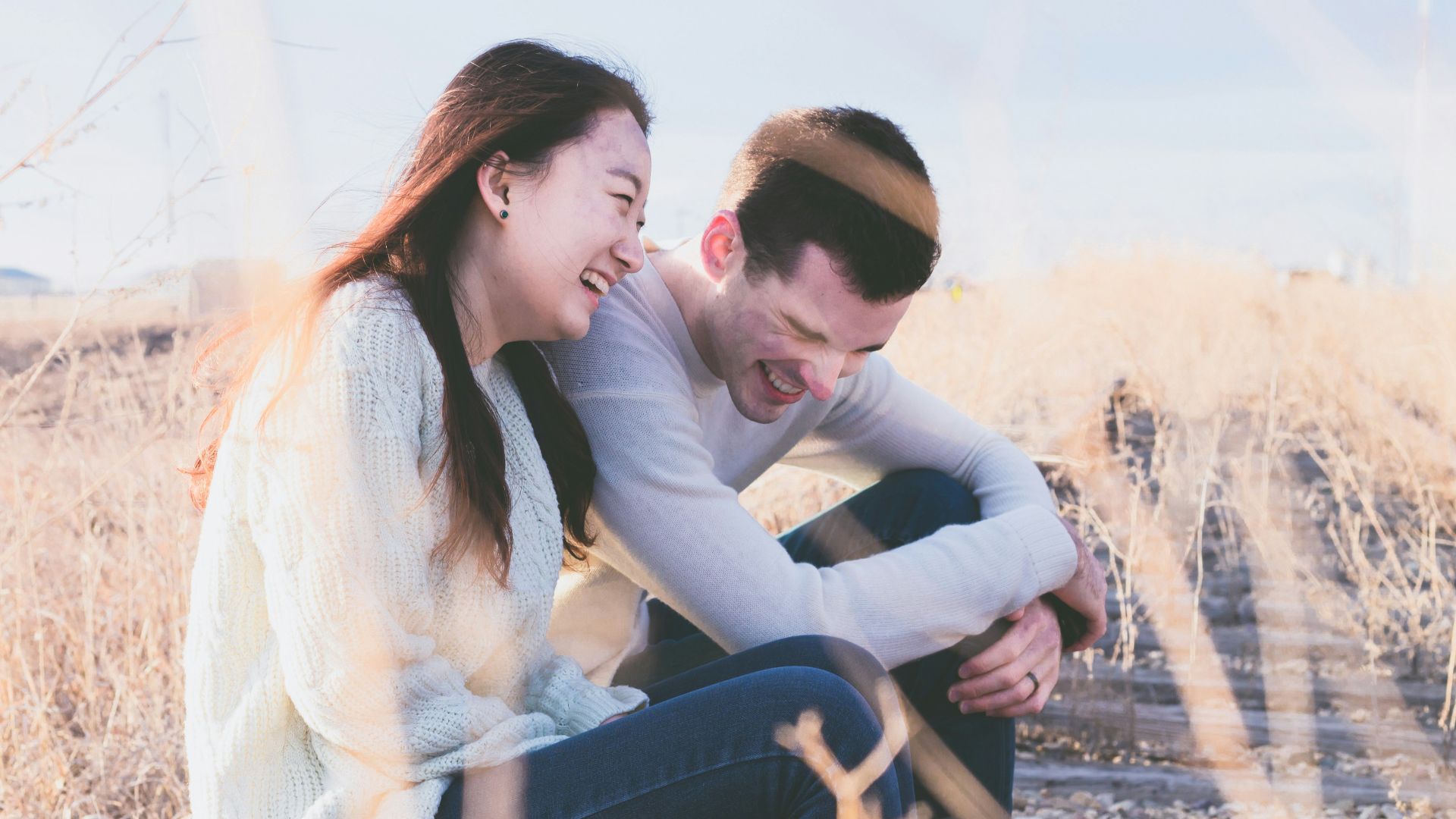 photo of man and woman laughing during daytime