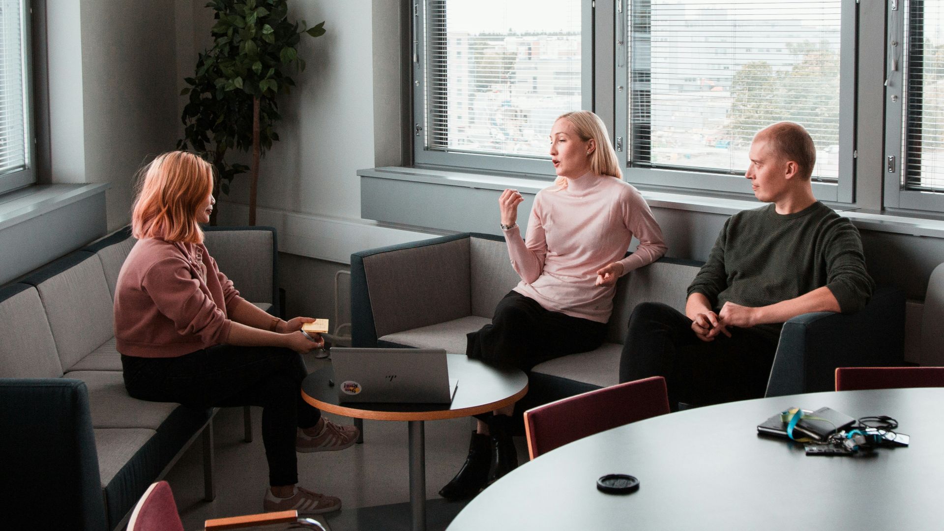 2 women sitting on black sofa