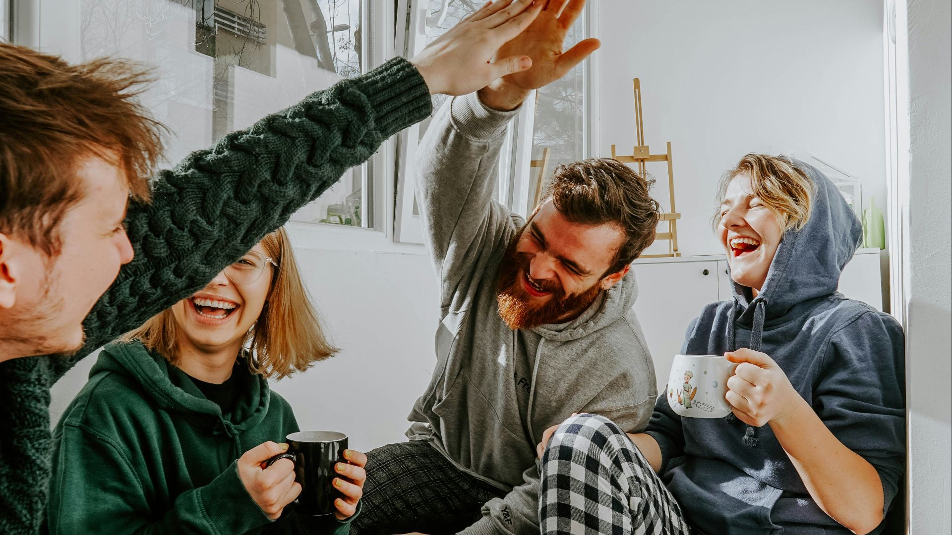 woman in black and white checkered long sleeve shirt sitting beside man in green crew neck