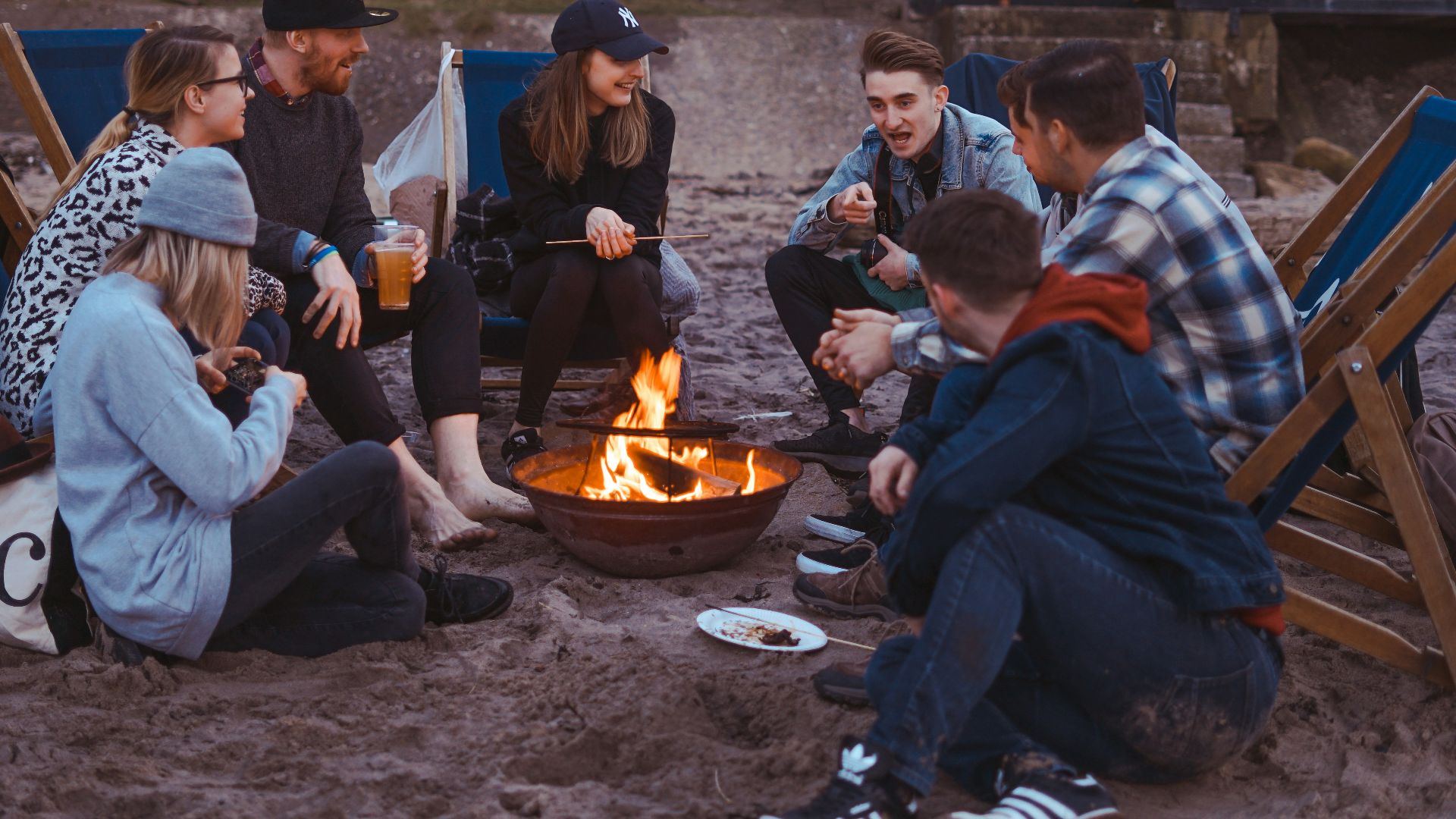 group of people sitting on front firepit