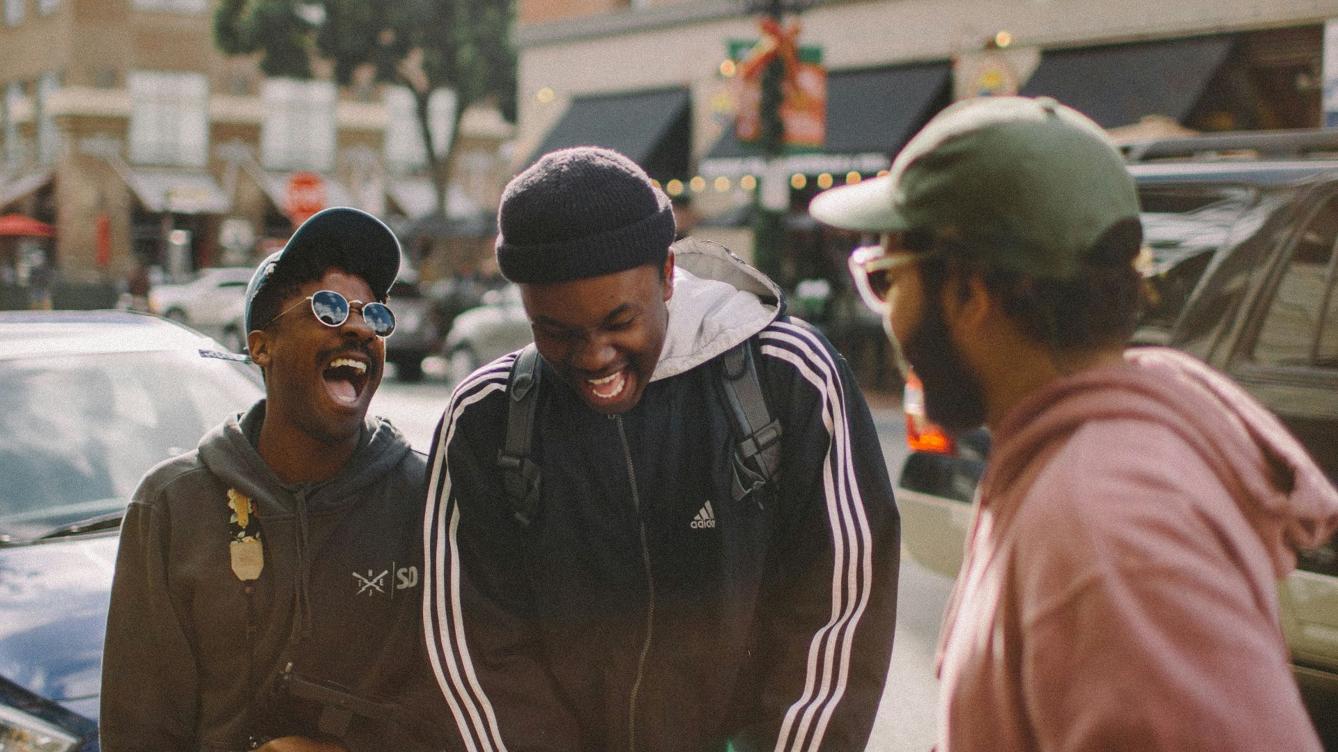 three men in jacket laughing at each other