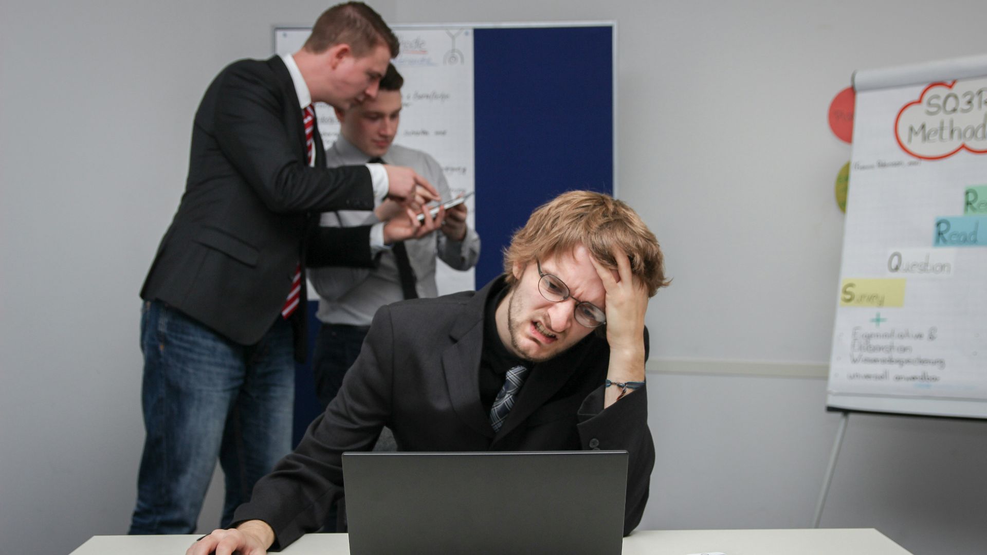 A man sitting in front of a laptop computer