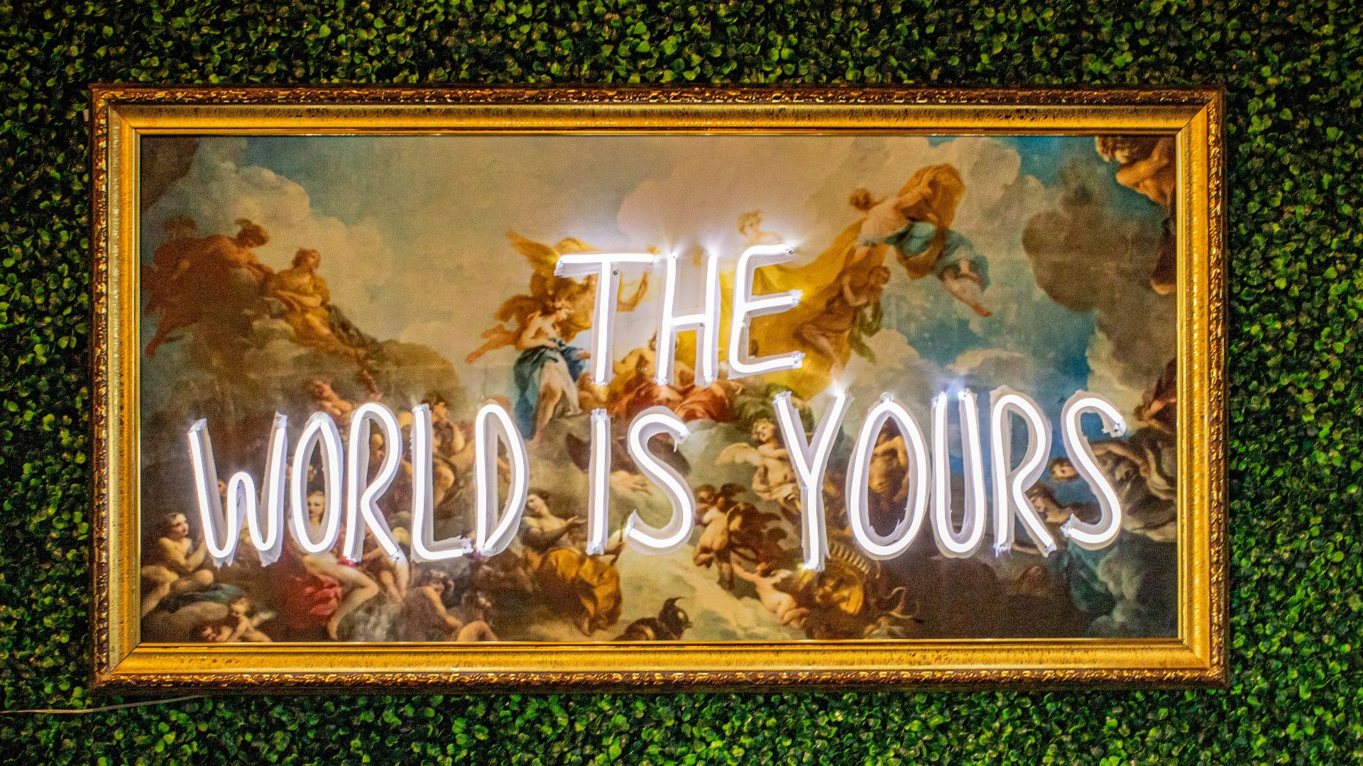 a sign that says the world is yours on a wall
