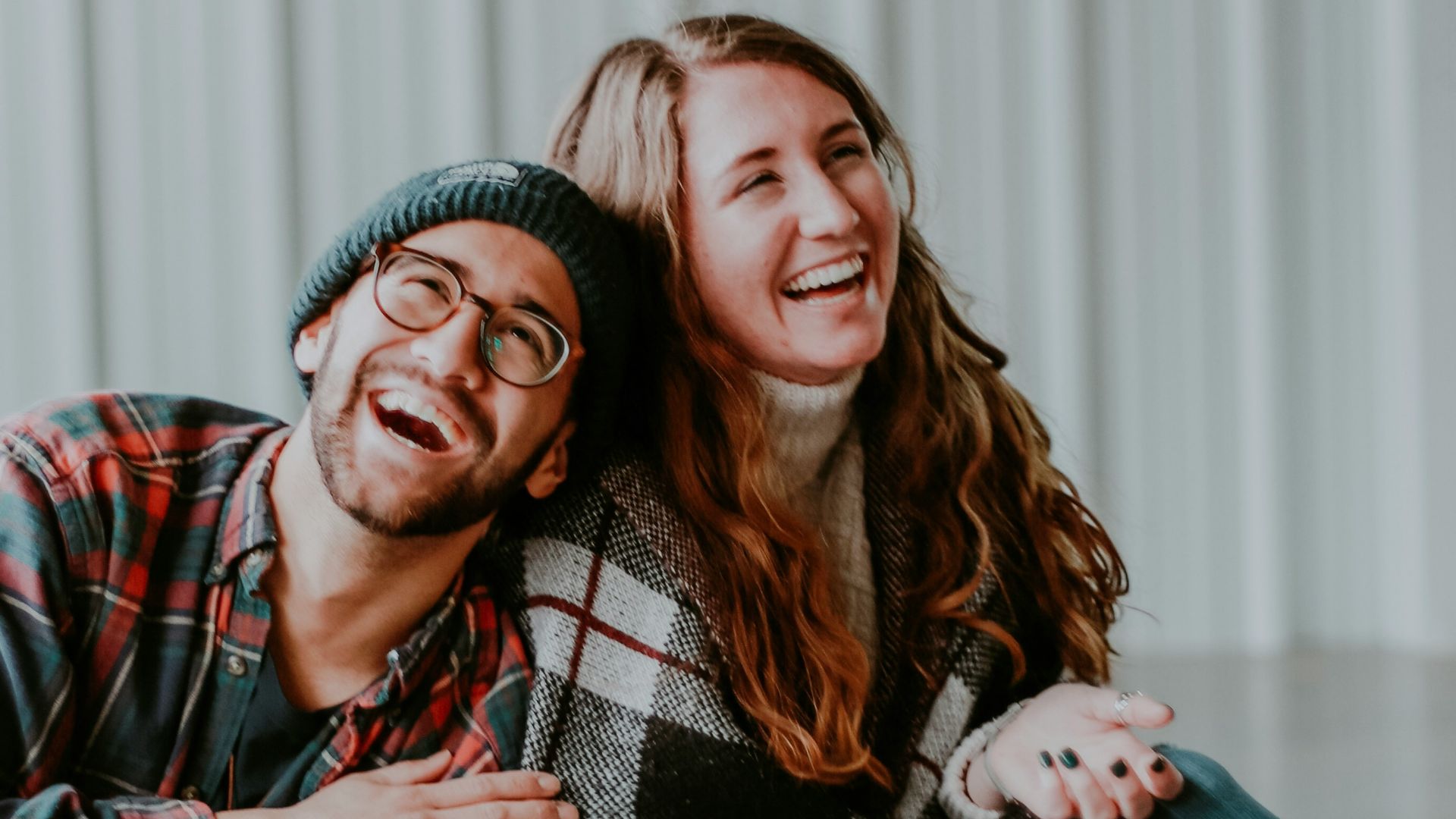 smiling woman and man sitting on floor