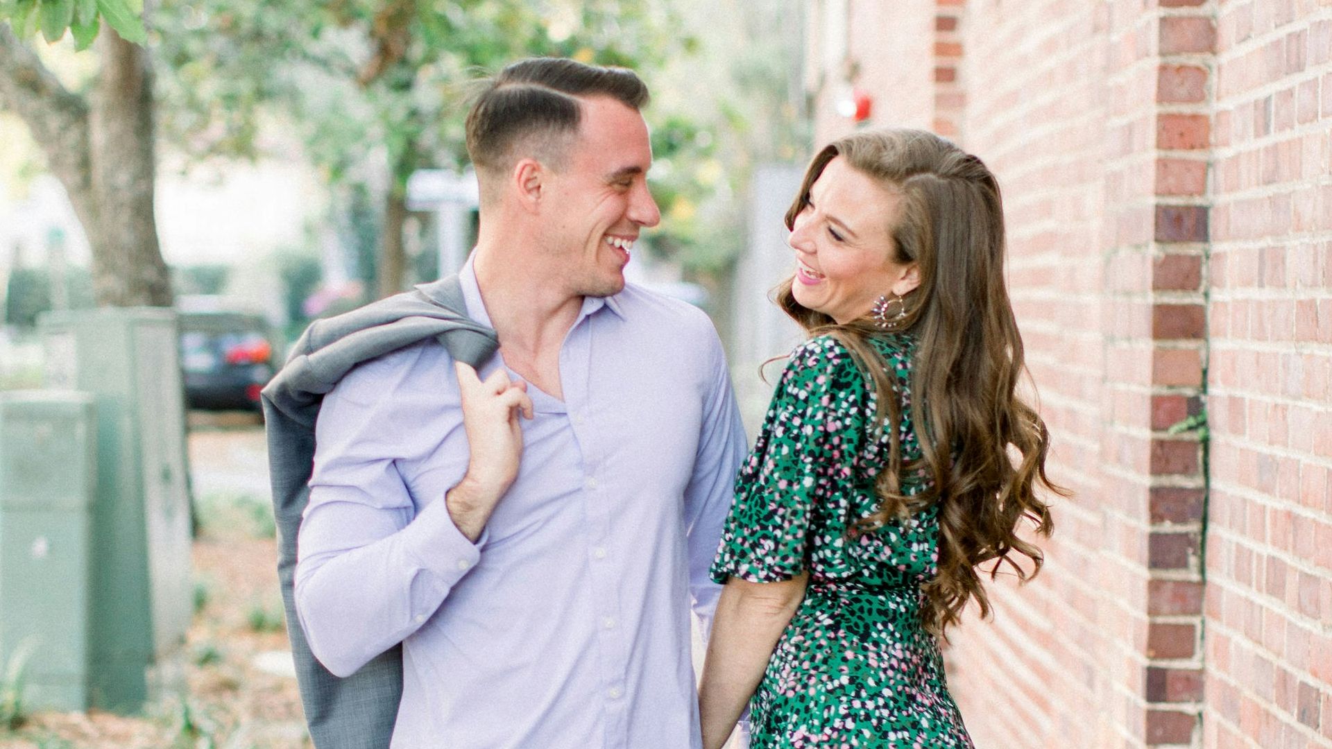 woman in white long sleeve shirt standing beside woman in green and white floral dress