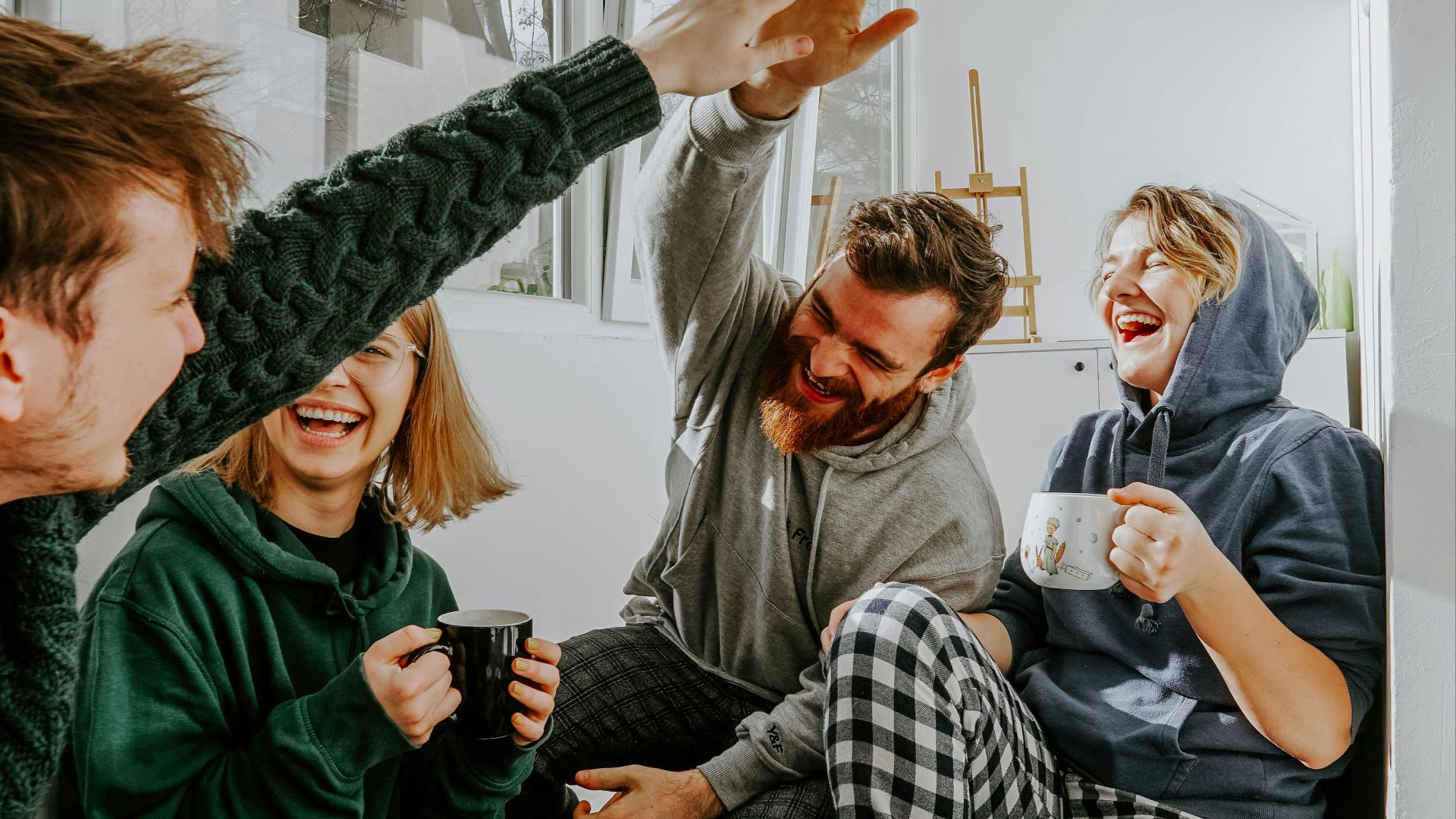 woman in black and white checkered long sleeve shirt sitting beside man in green crew neck