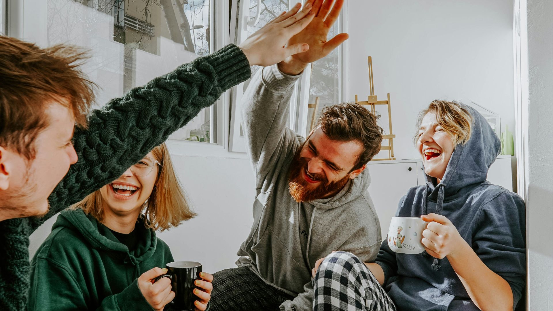 woman in black and white checkered long sleeve shirt sitting beside man in green crew neck