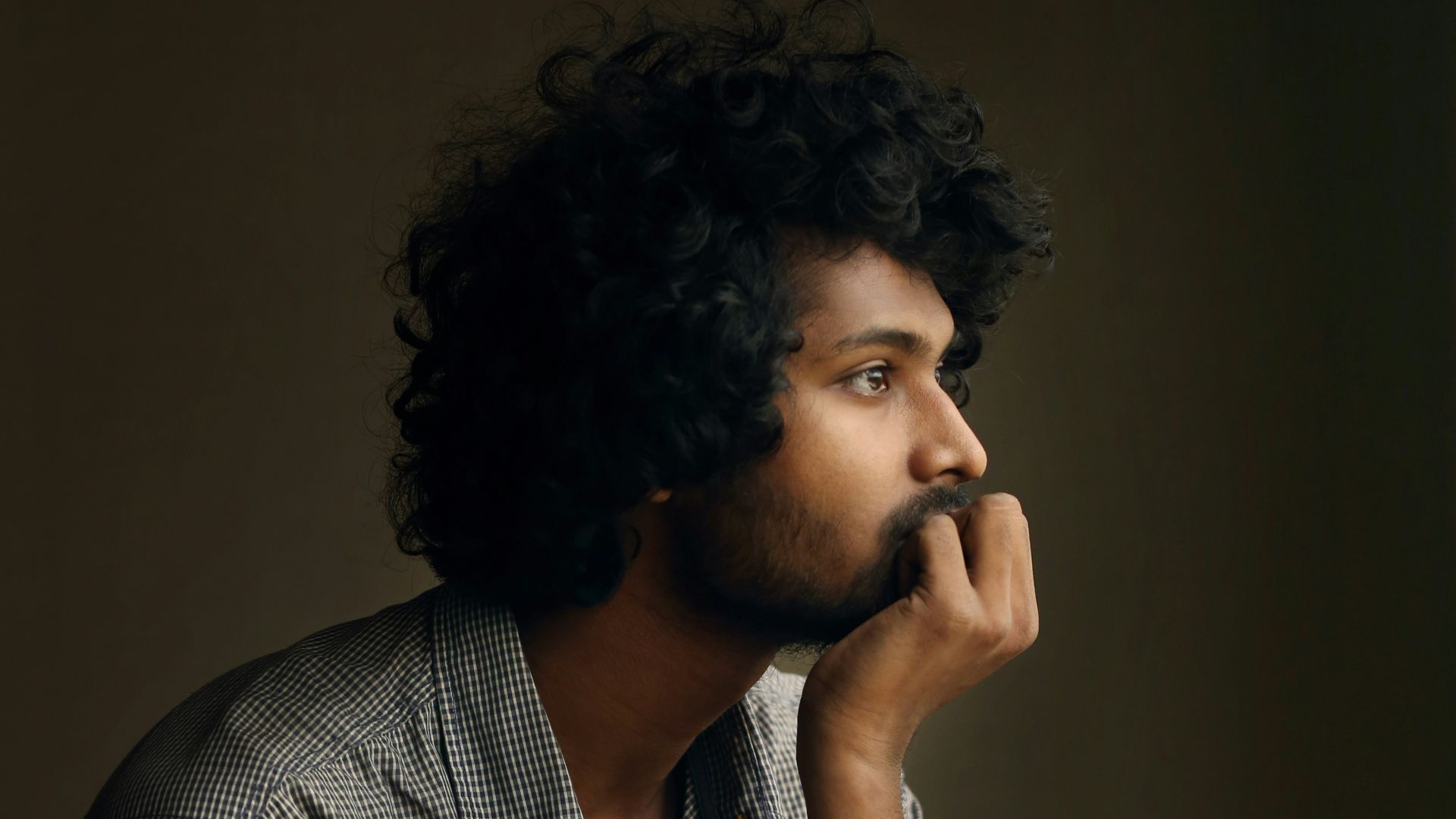 man in gray and white checkered dress shirt
