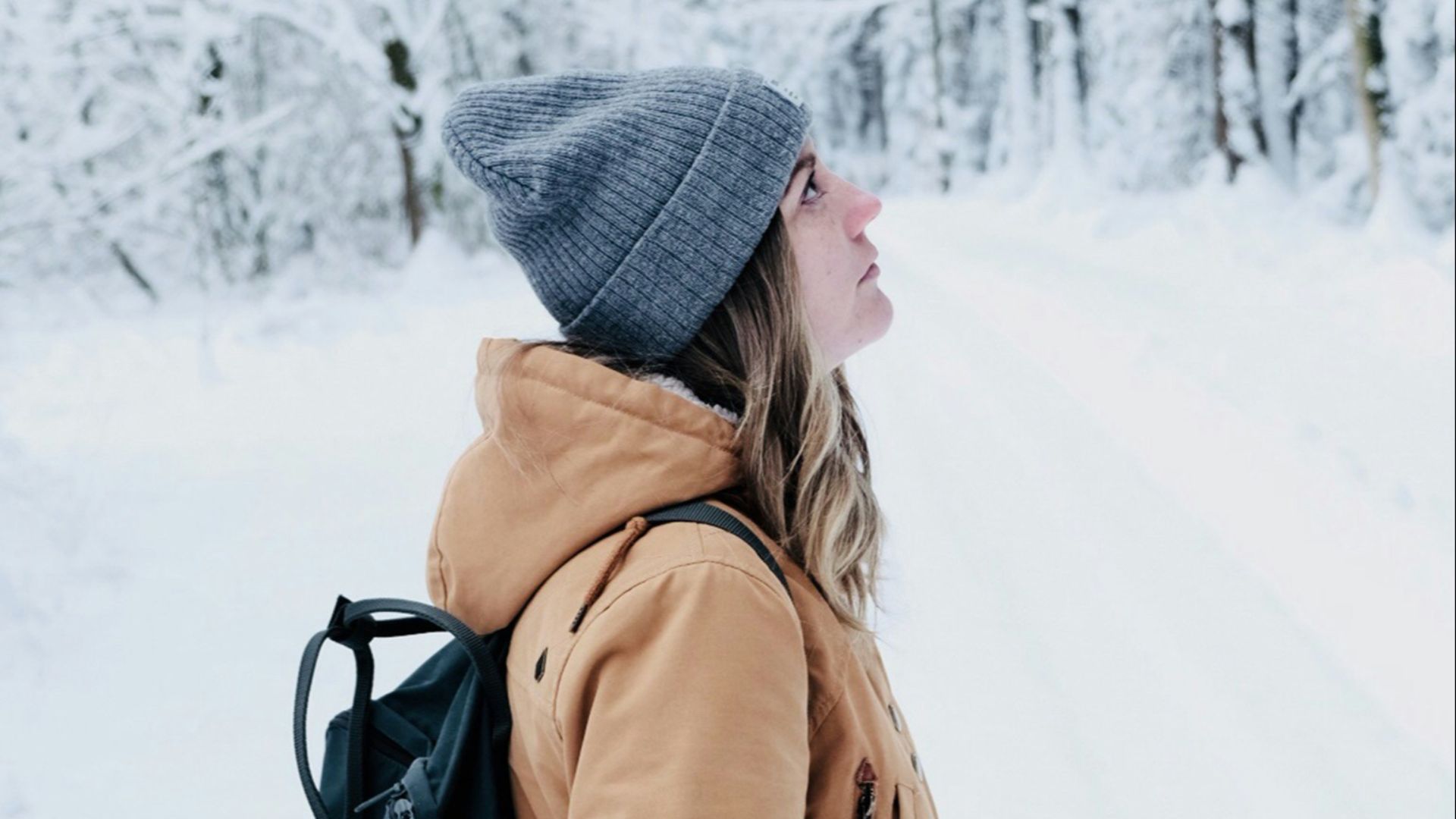 woman walking in snow covered forest