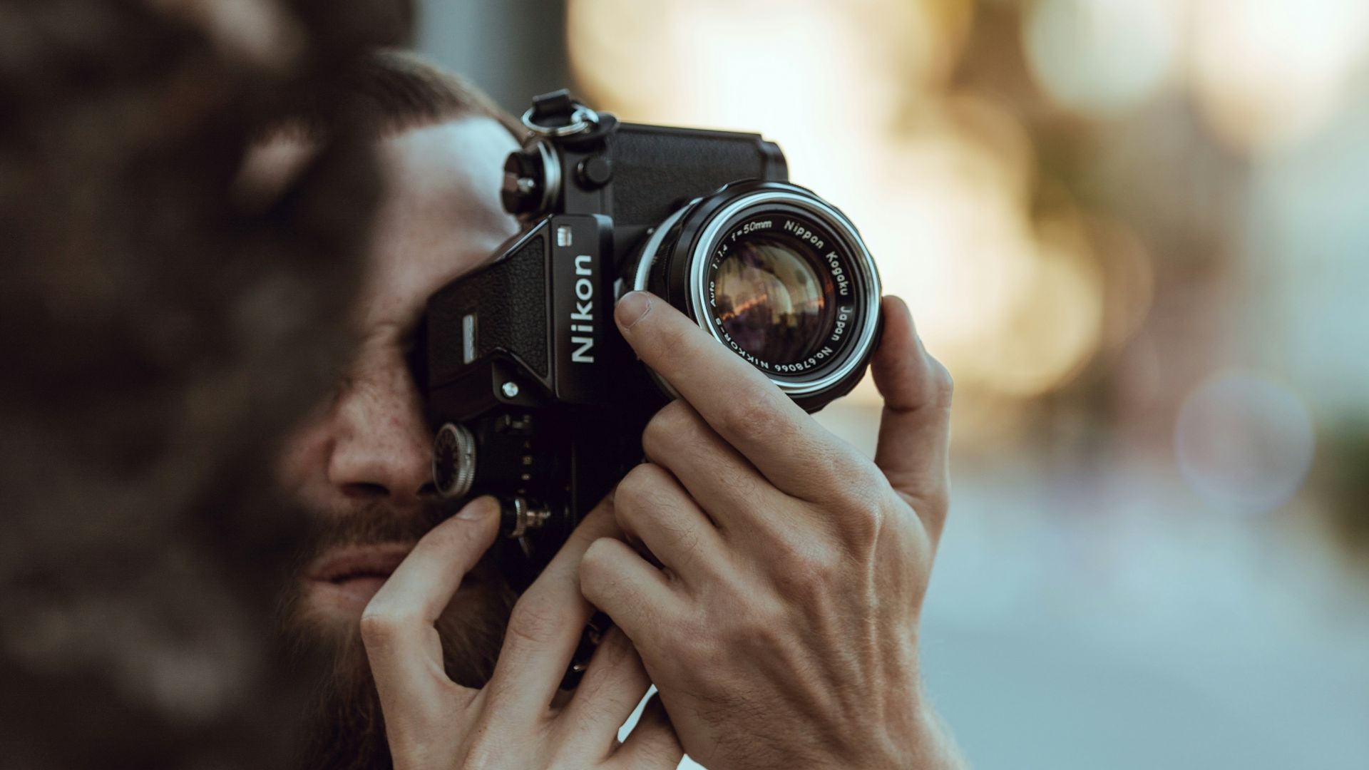 person using black Nikon DSLR camera