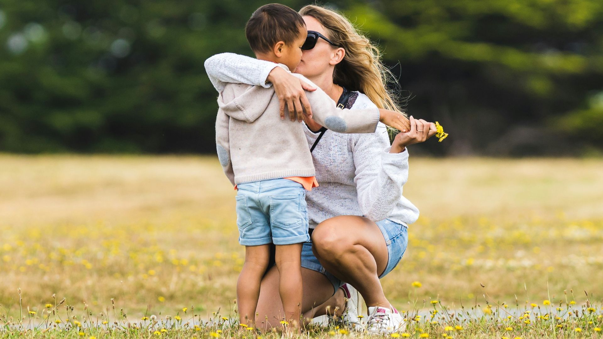 a couple of people that are standing in the grass