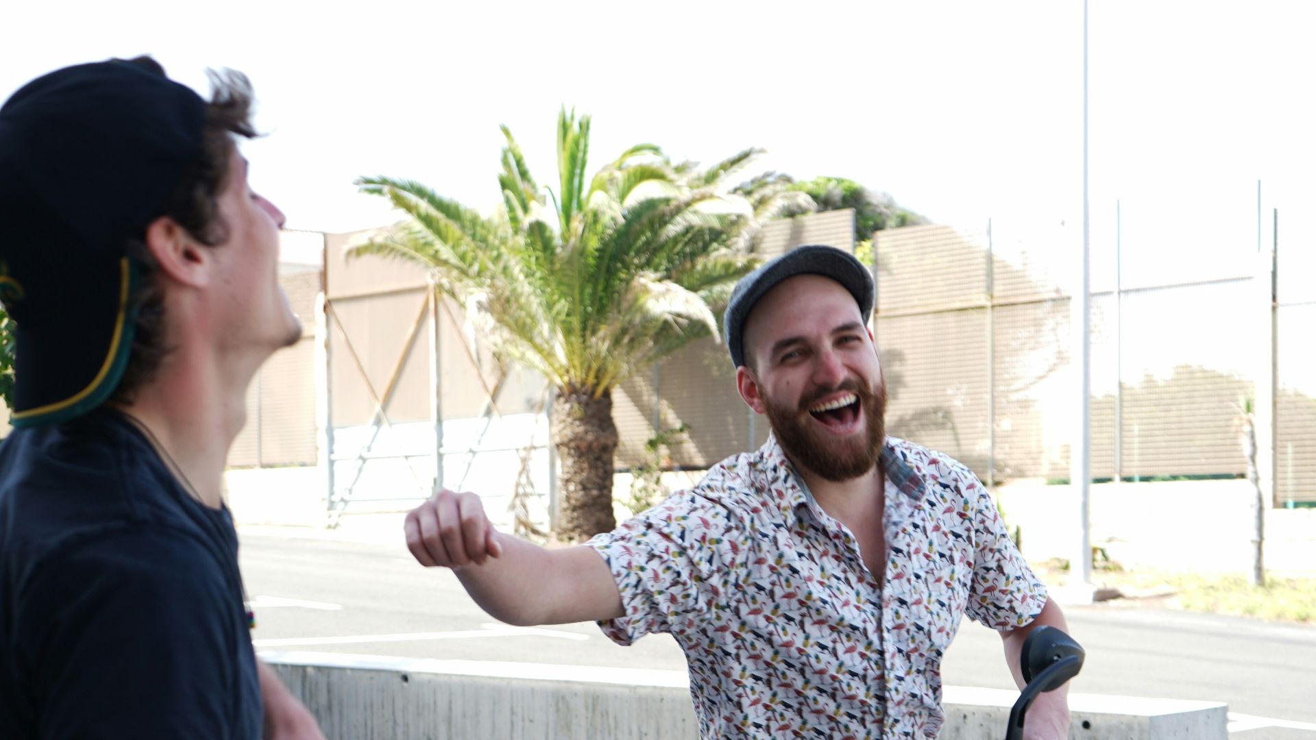 man in blue crew neck t-shirt standing beside woman in white and blue floral shirt
