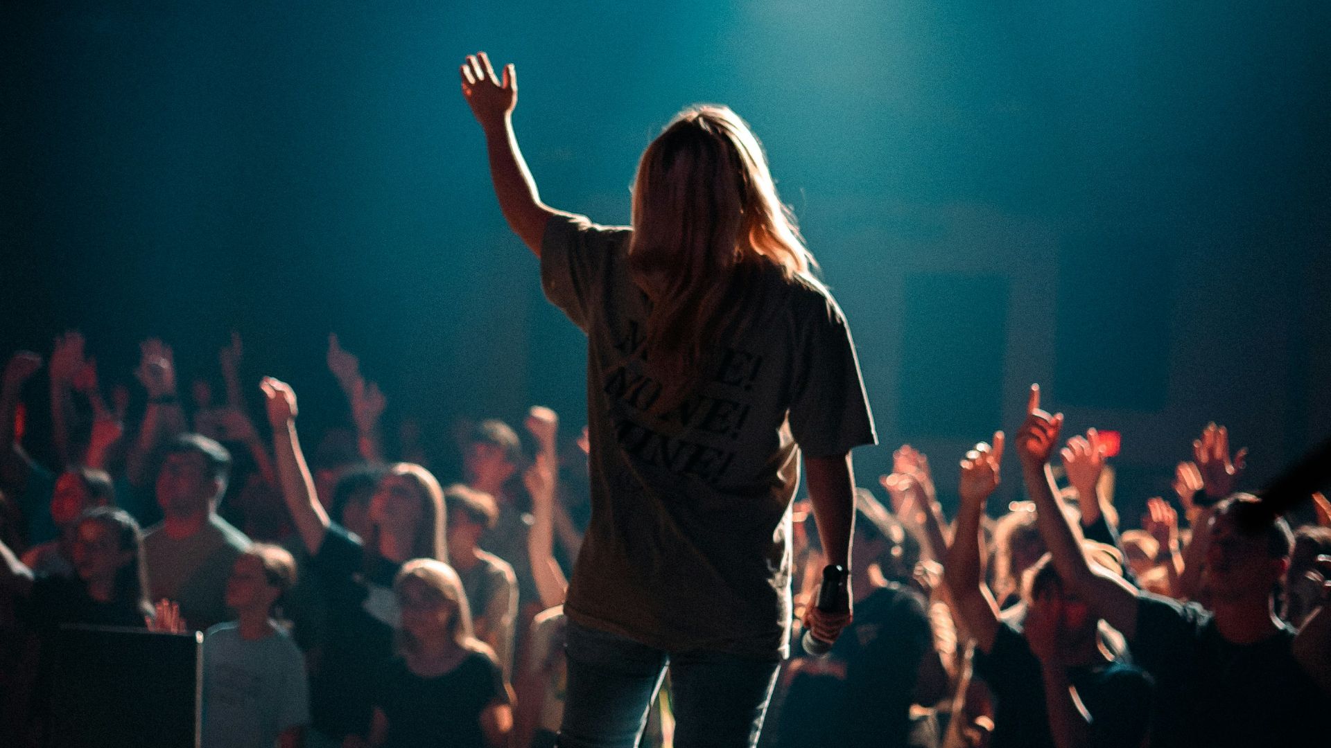 woman in black jacket standing on stage