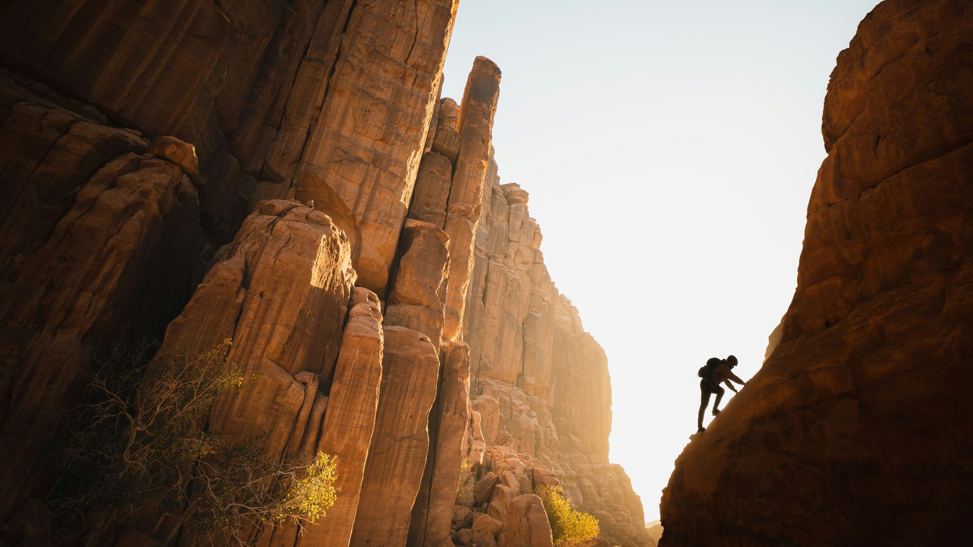 a man climbing up the side of a mountain