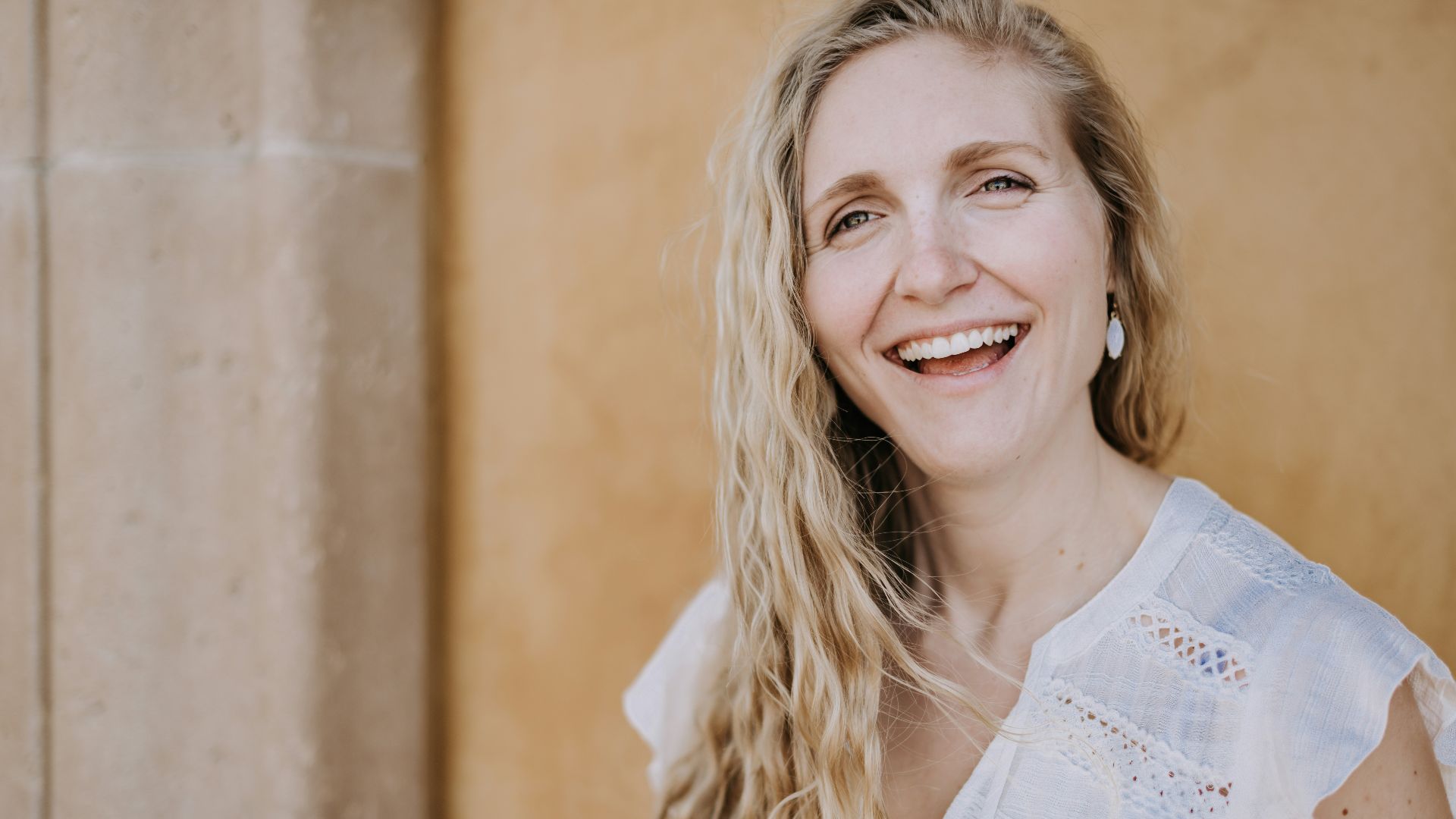 smiling woman in white lace shirt