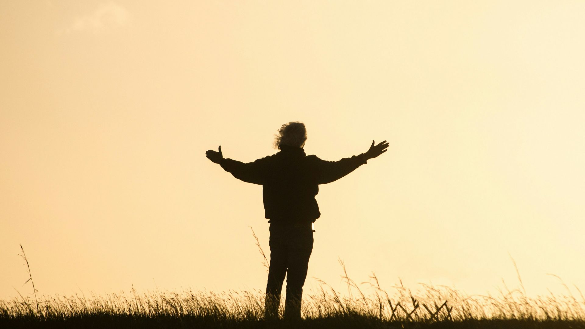 silhouette of person spreading hands