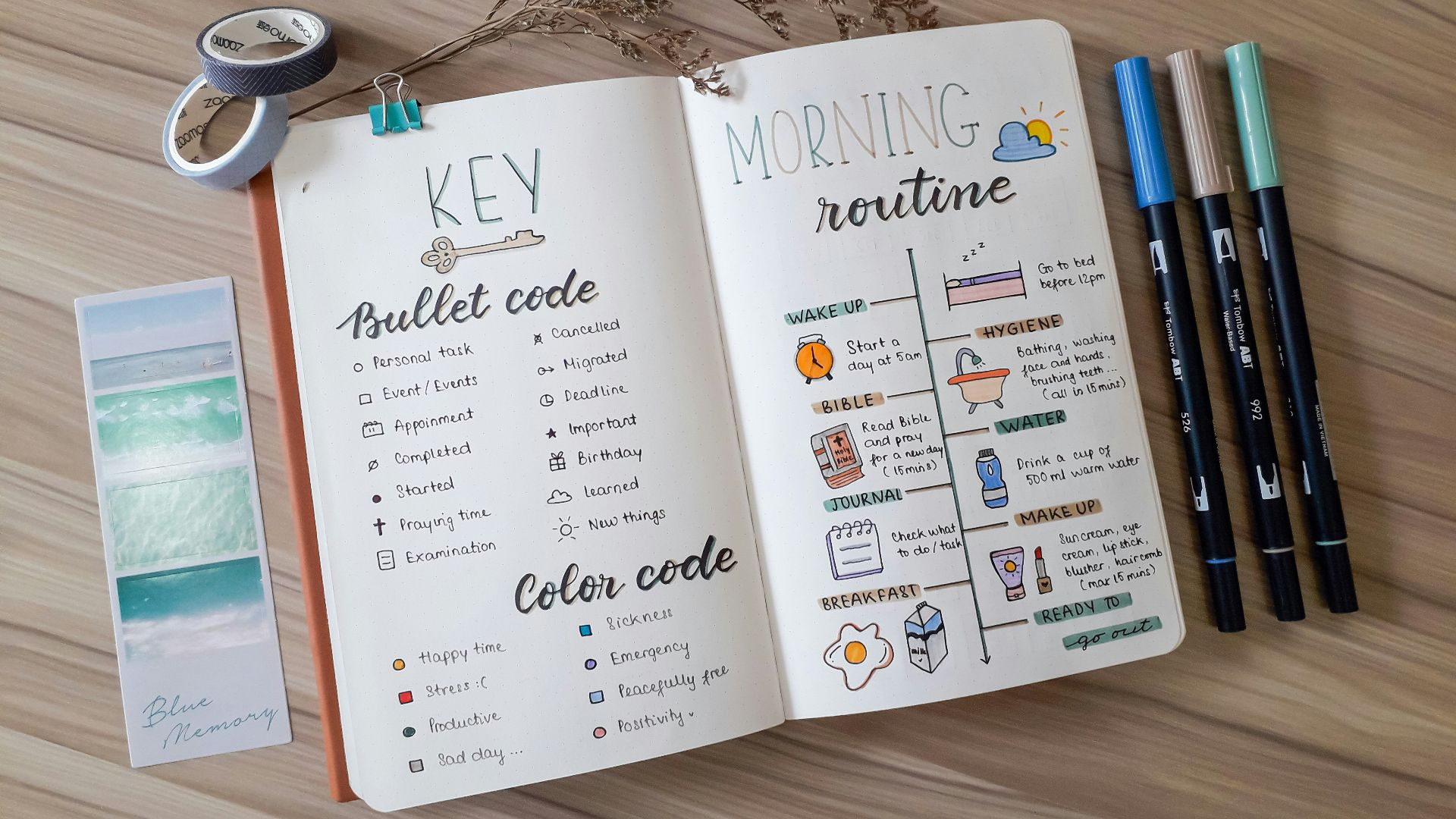 an open book with writing on it next to a pair of scissors